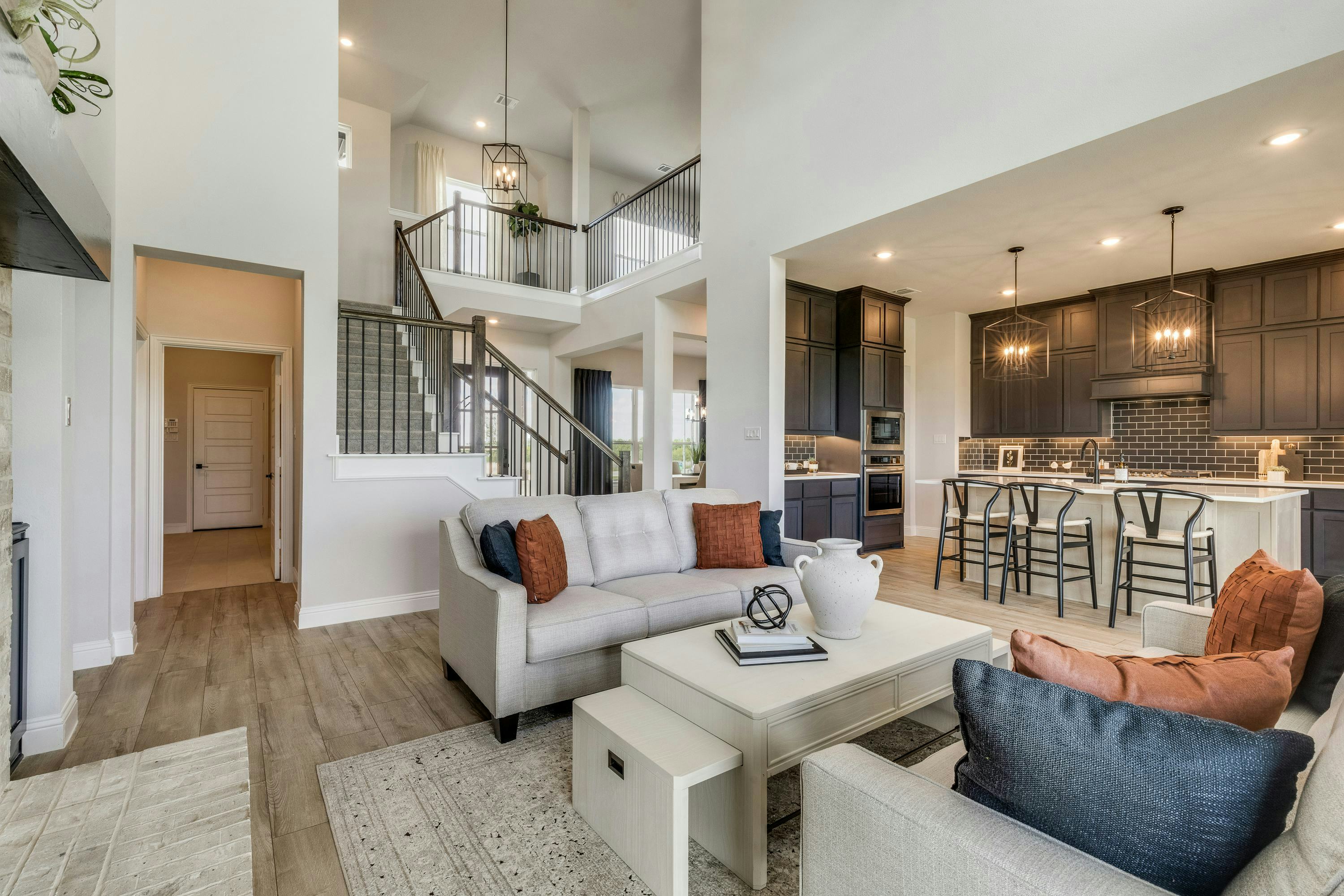 Living room, kitchen, and staircse of Berkshire Estates home in Mesquite, TX by Kindred Homes