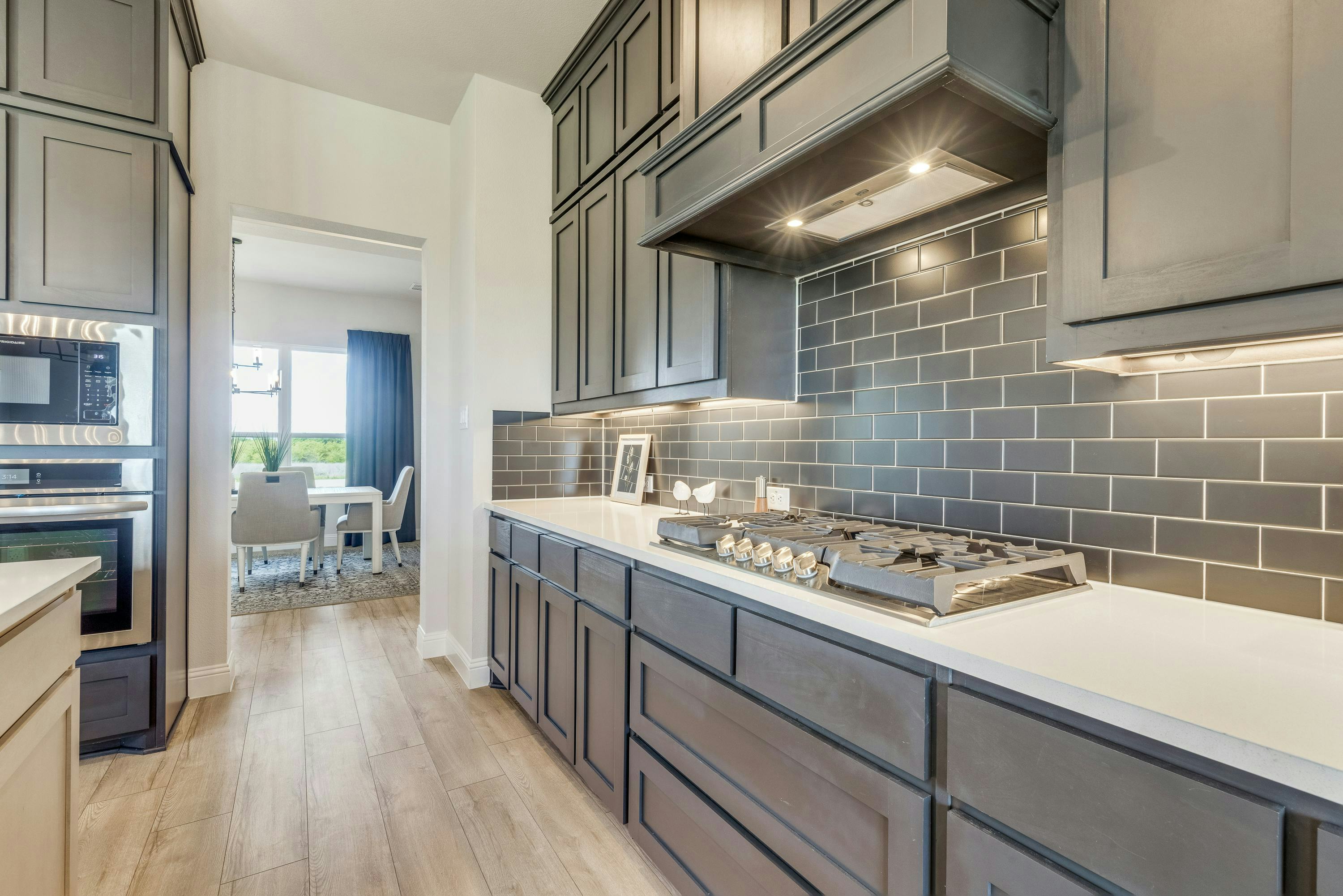Stovetop of kitchen inside Berkshire Estates home in Mesquite, TX by Kindred Homes