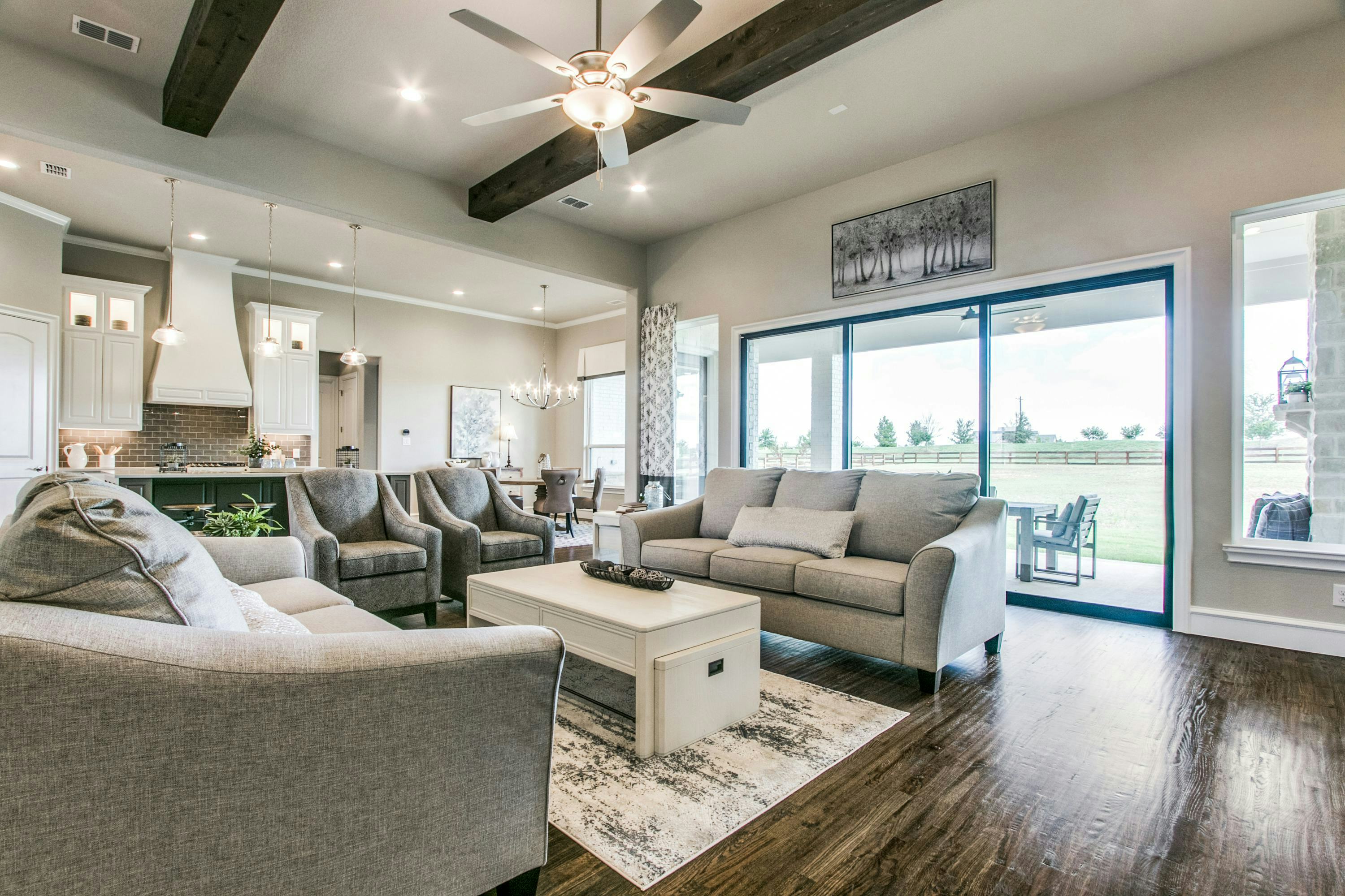 Living room and kitchen of The Highlands of Northlake home in Northlake, TX by Kindred Homes