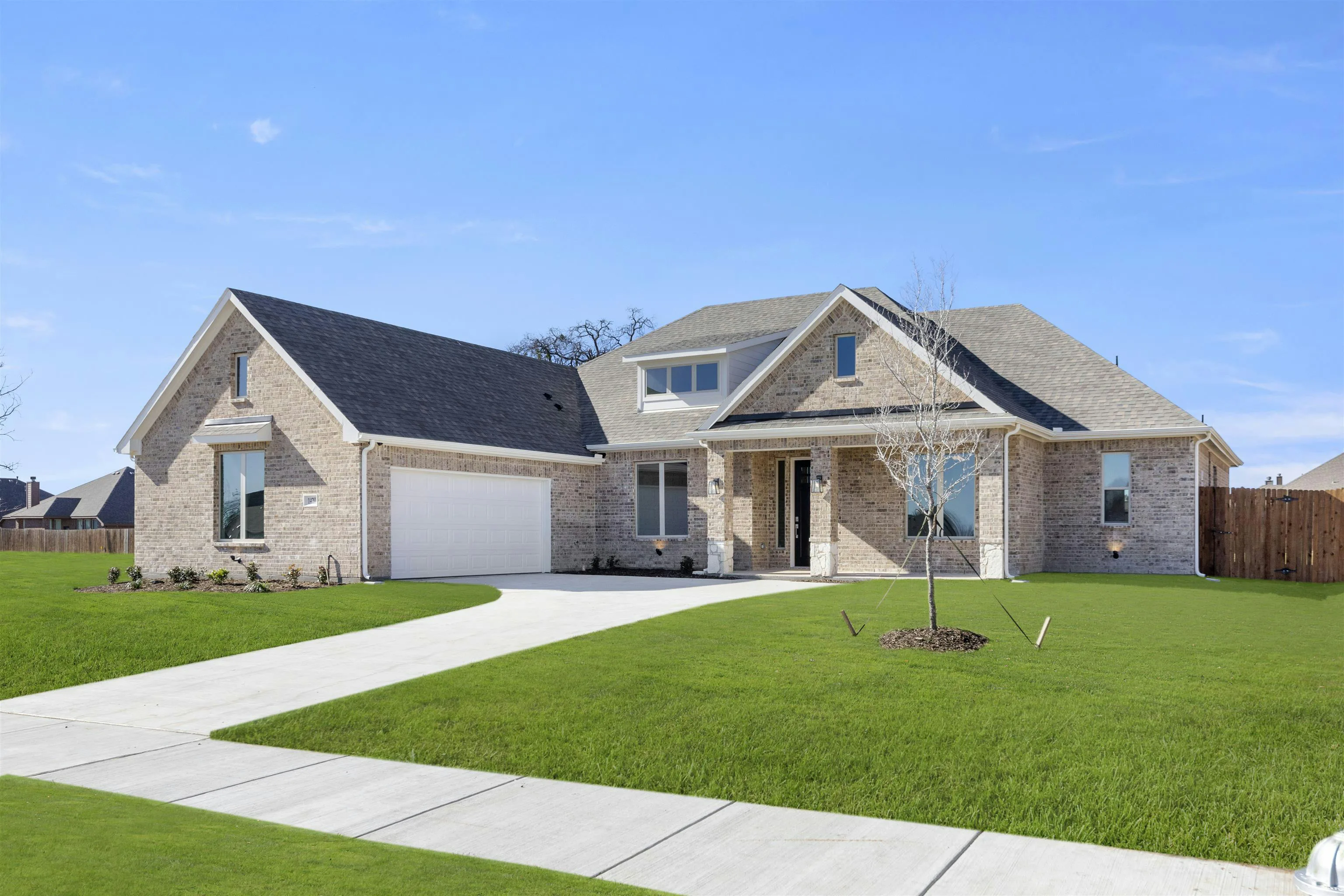 Side view exterior of a transitional ranch style home by Kindred Homes
