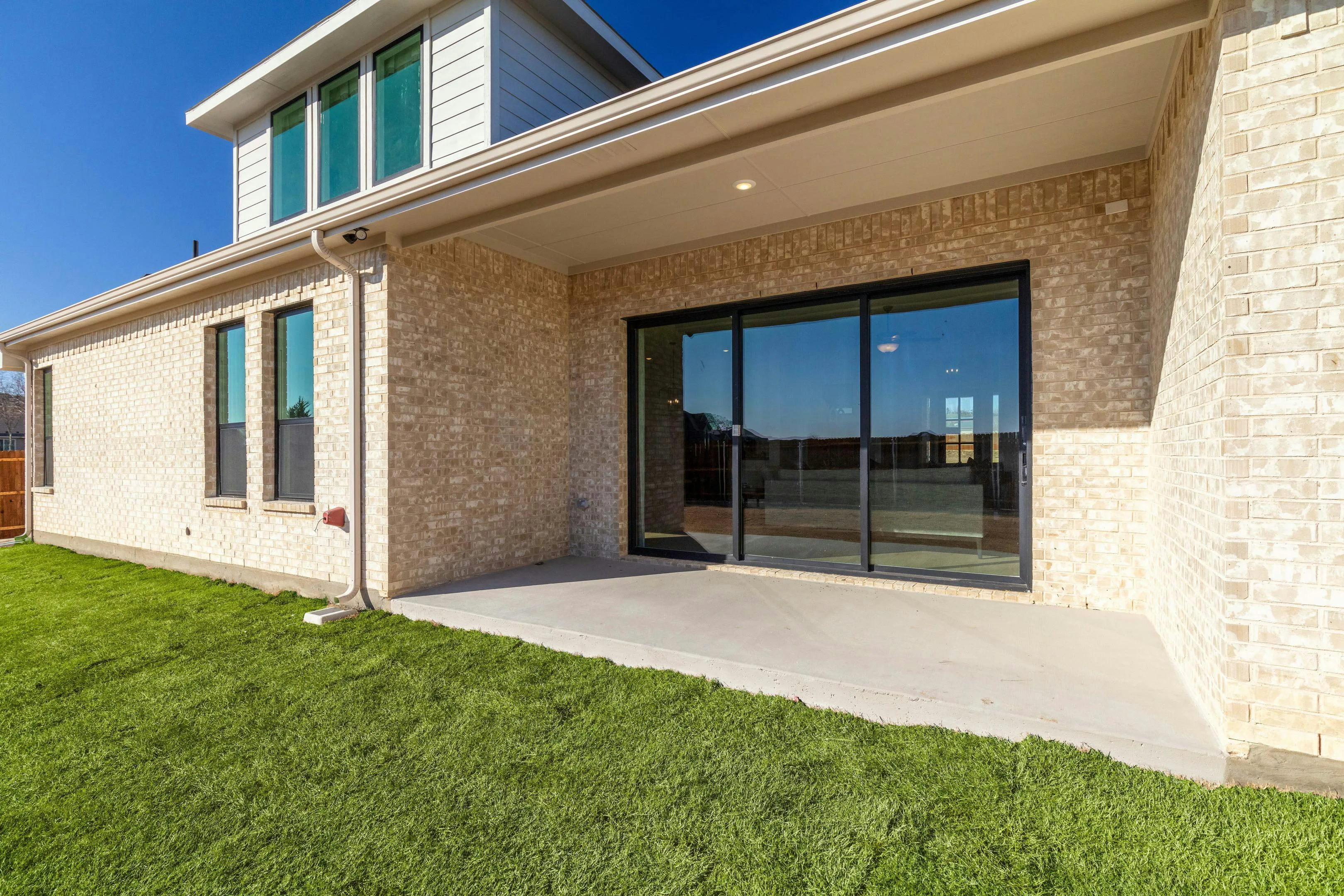 Covered outdoor living of model home at Kentsdale Farms by Kindred Homes in DeSoto