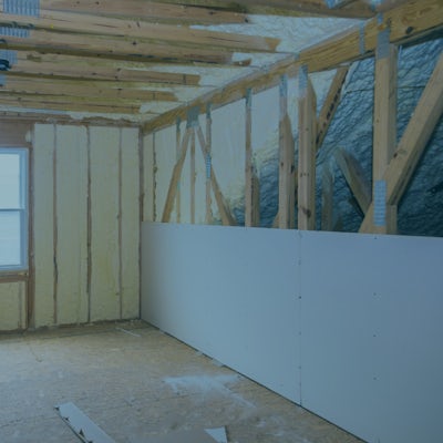 Image Showing Drywall Being Placed over Spray Foam
