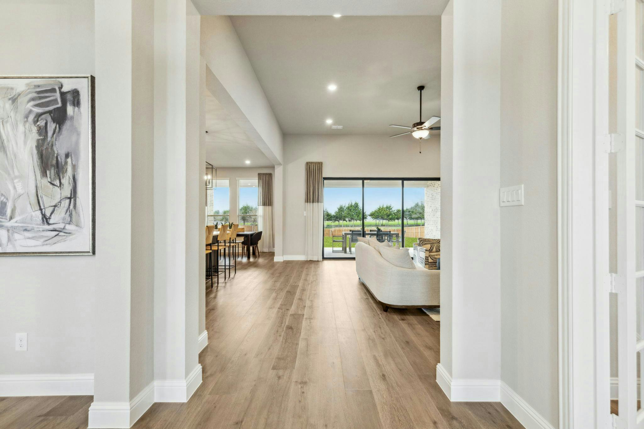 View of entry, living room, and kitchen of Hampton Park Estates home in Glenn Heights, TX by Kindred Homes