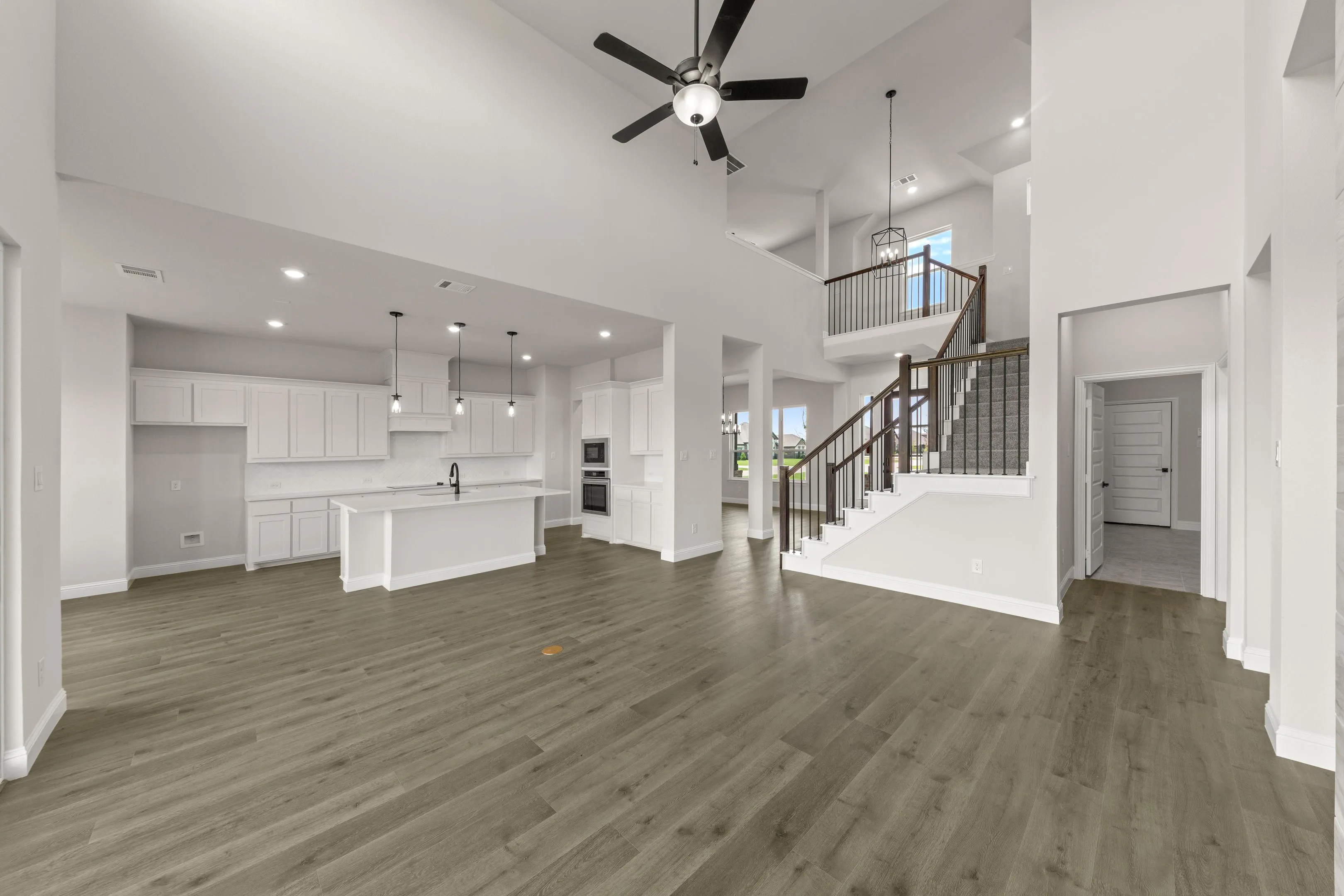Open concept living room and kitchen in a new traditional style home by Kindred Homes