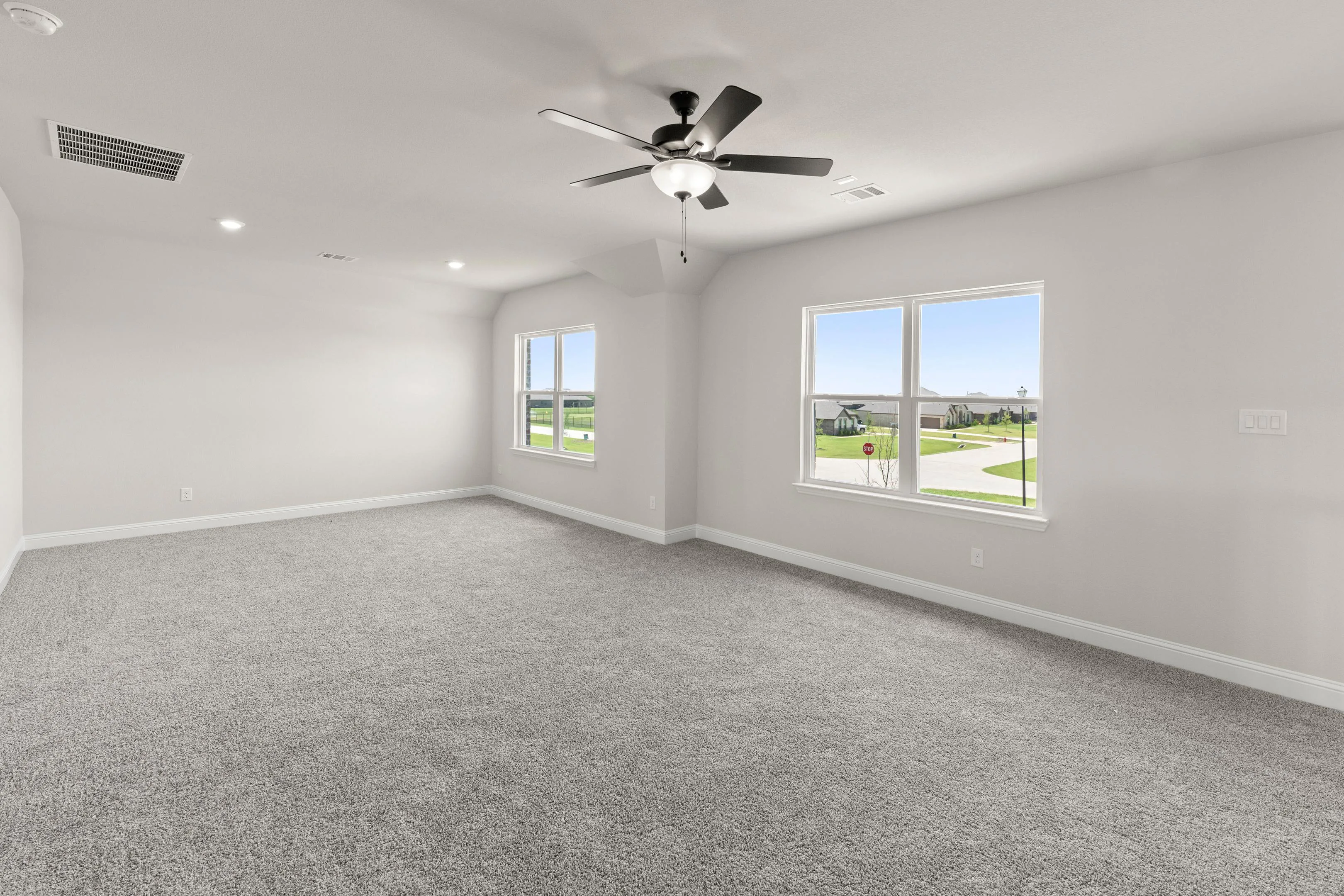 Spacious game room in a new traditional style home by Kindred Homes