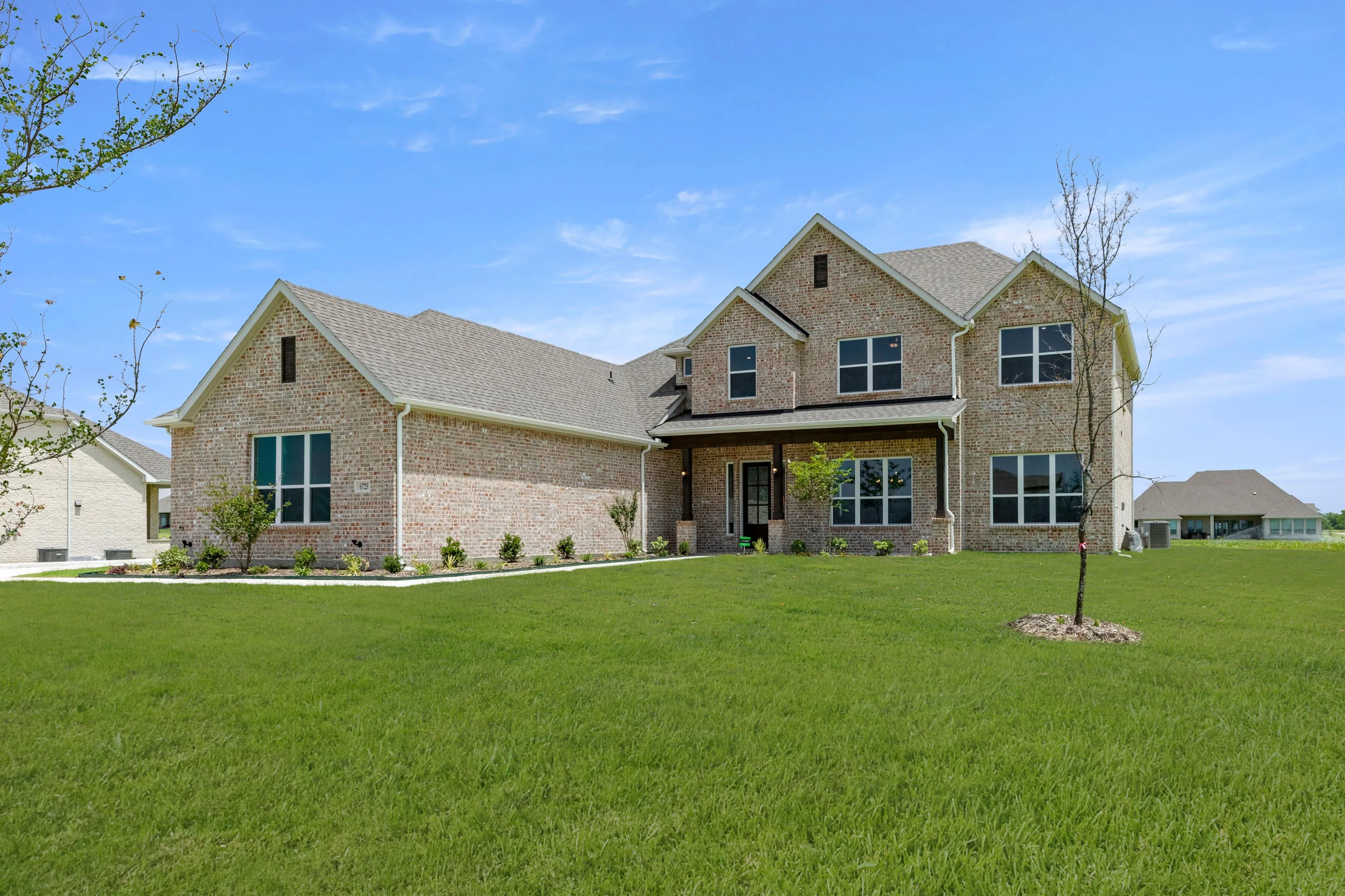 Exterior of a two-story new traditional style home by Kindred Homes
