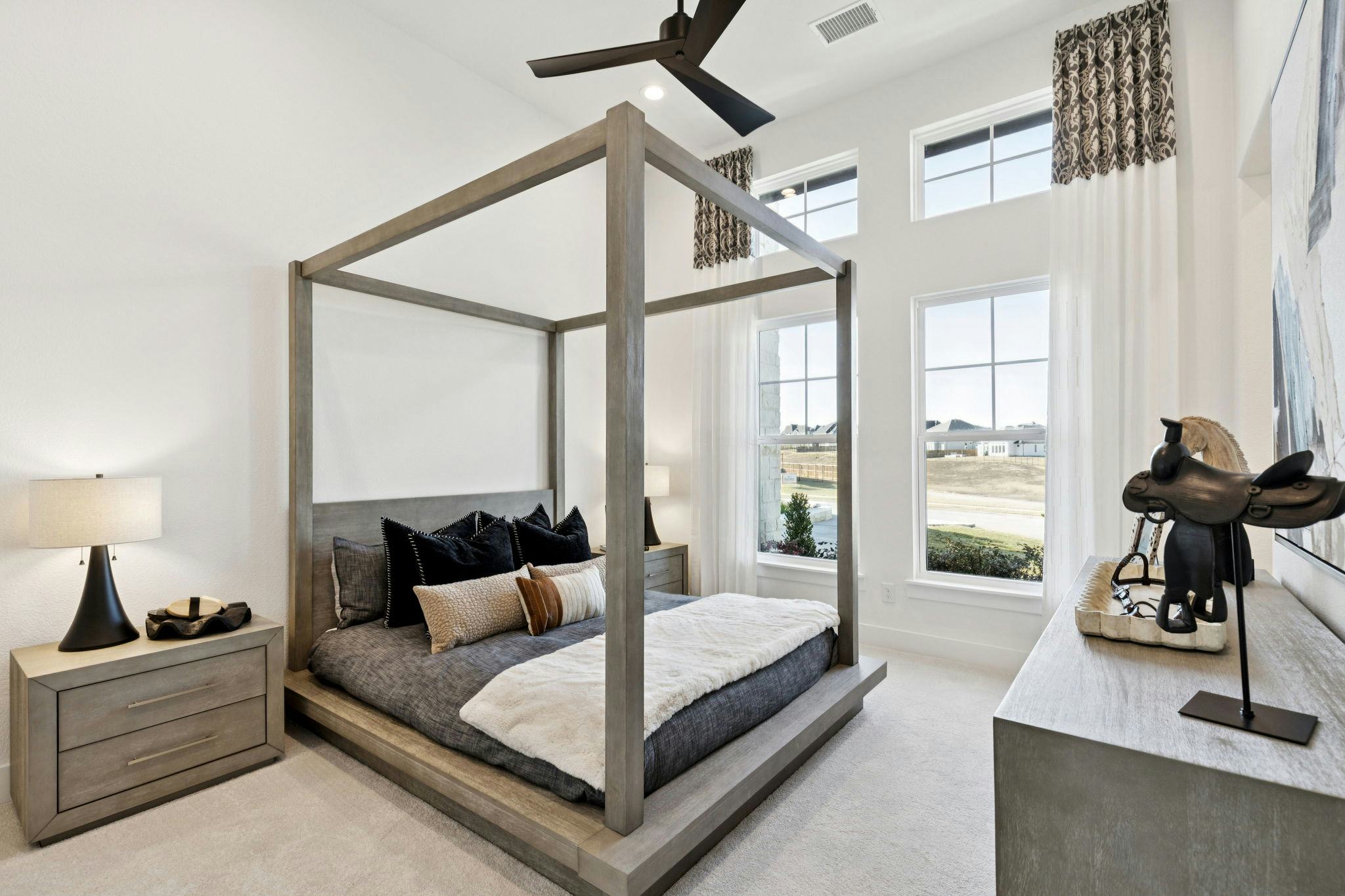 A secondary bedroom in the custom model home at The Vines by Kindred Homes