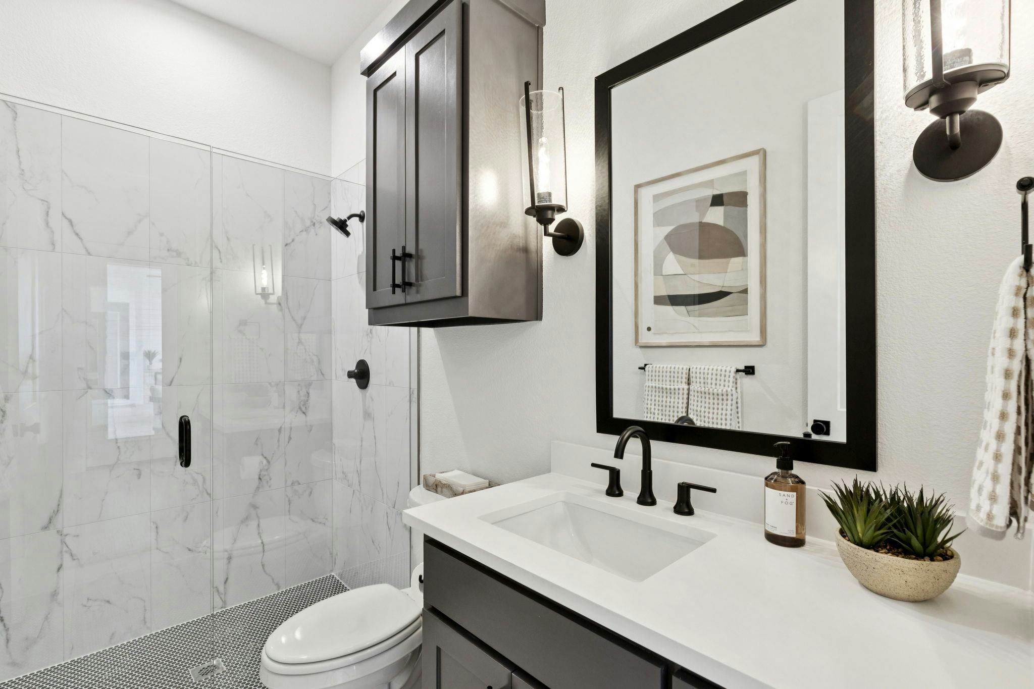 A secondary bathroom in the custom model home at The Vines by Kindred Homes