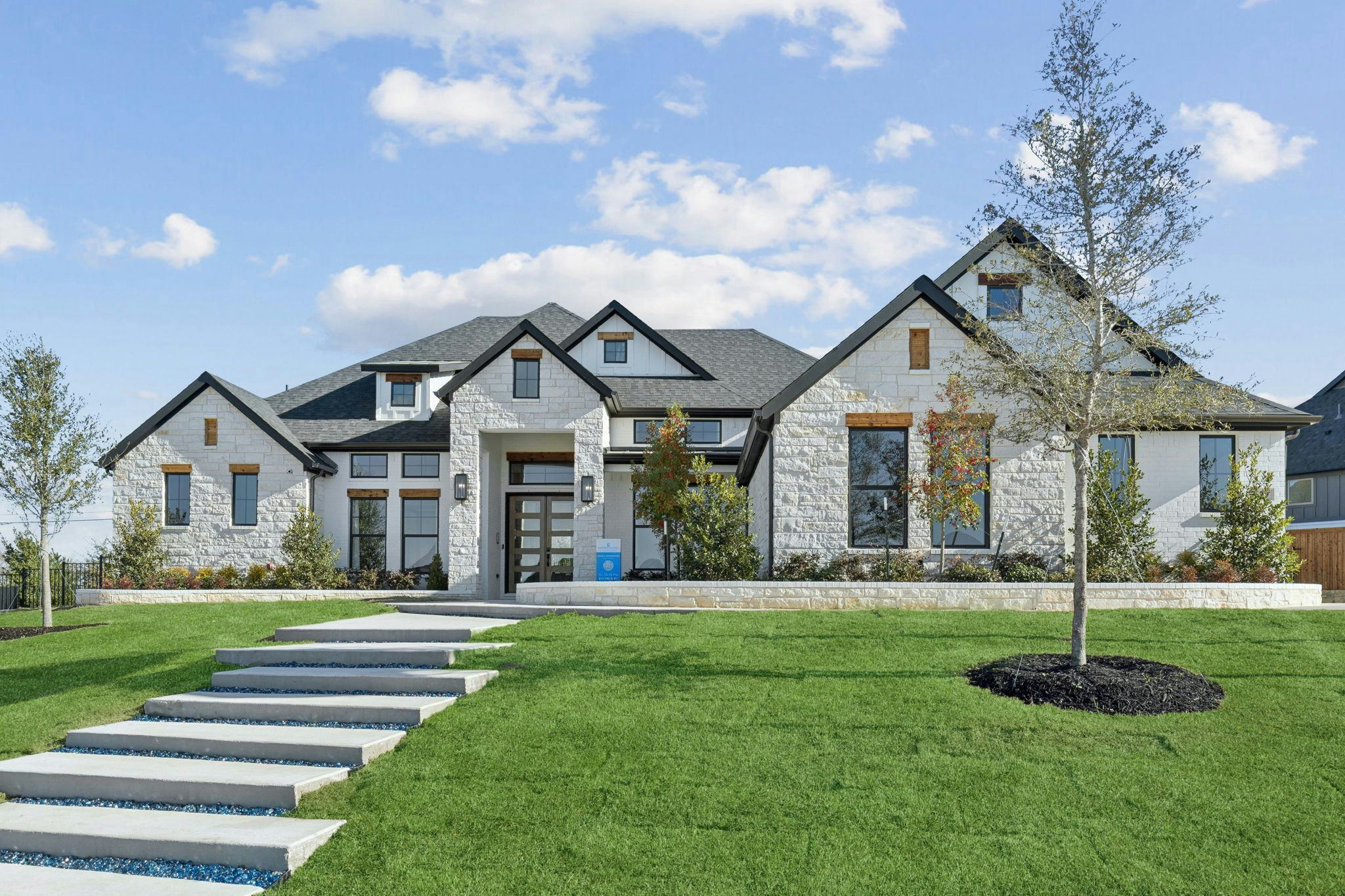 The front exterior of the custom model home at The Vines by Kindred Homes