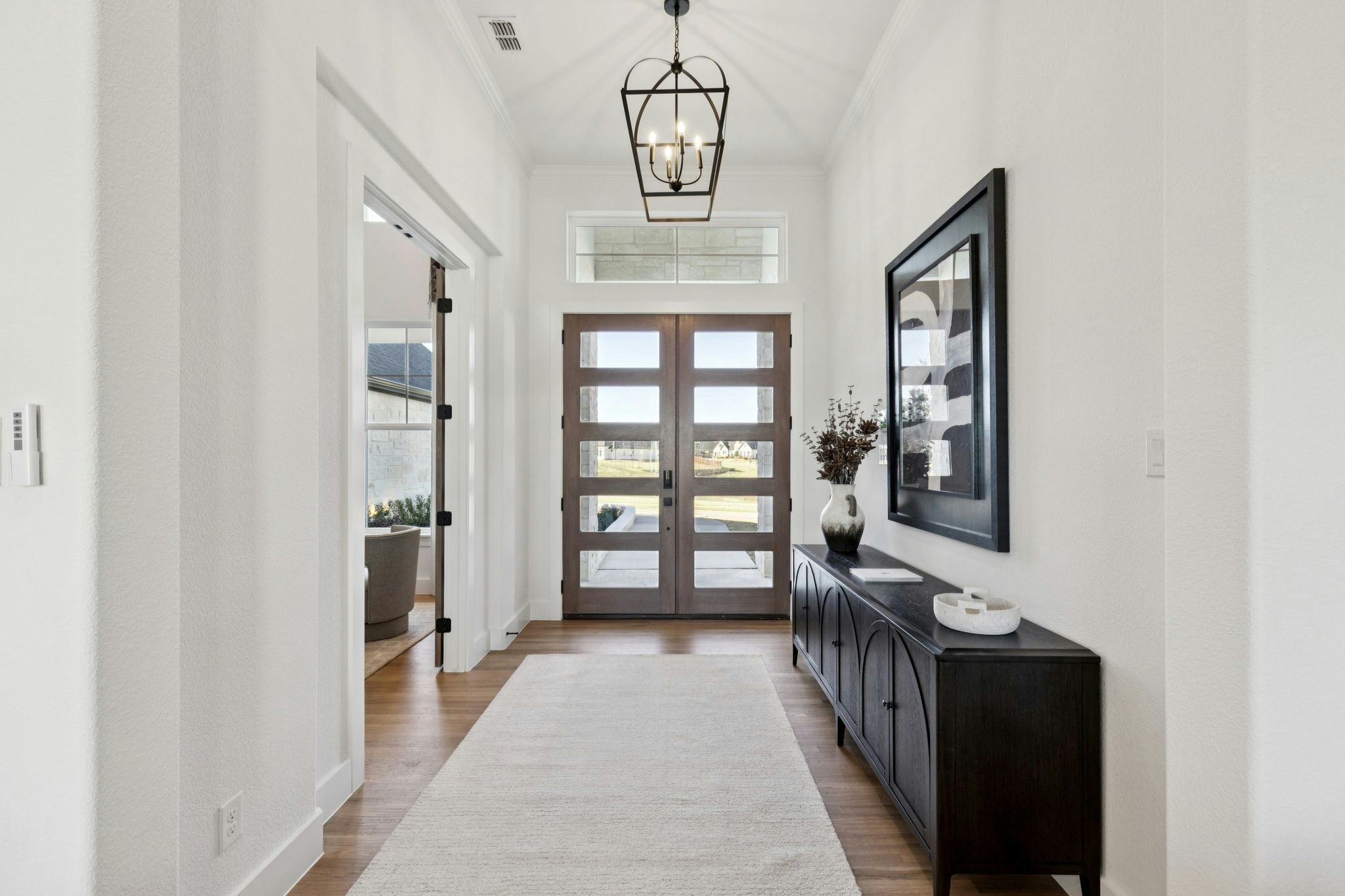 The grand entry with double front doors in the custom model home at The Vines by Kindred Homes