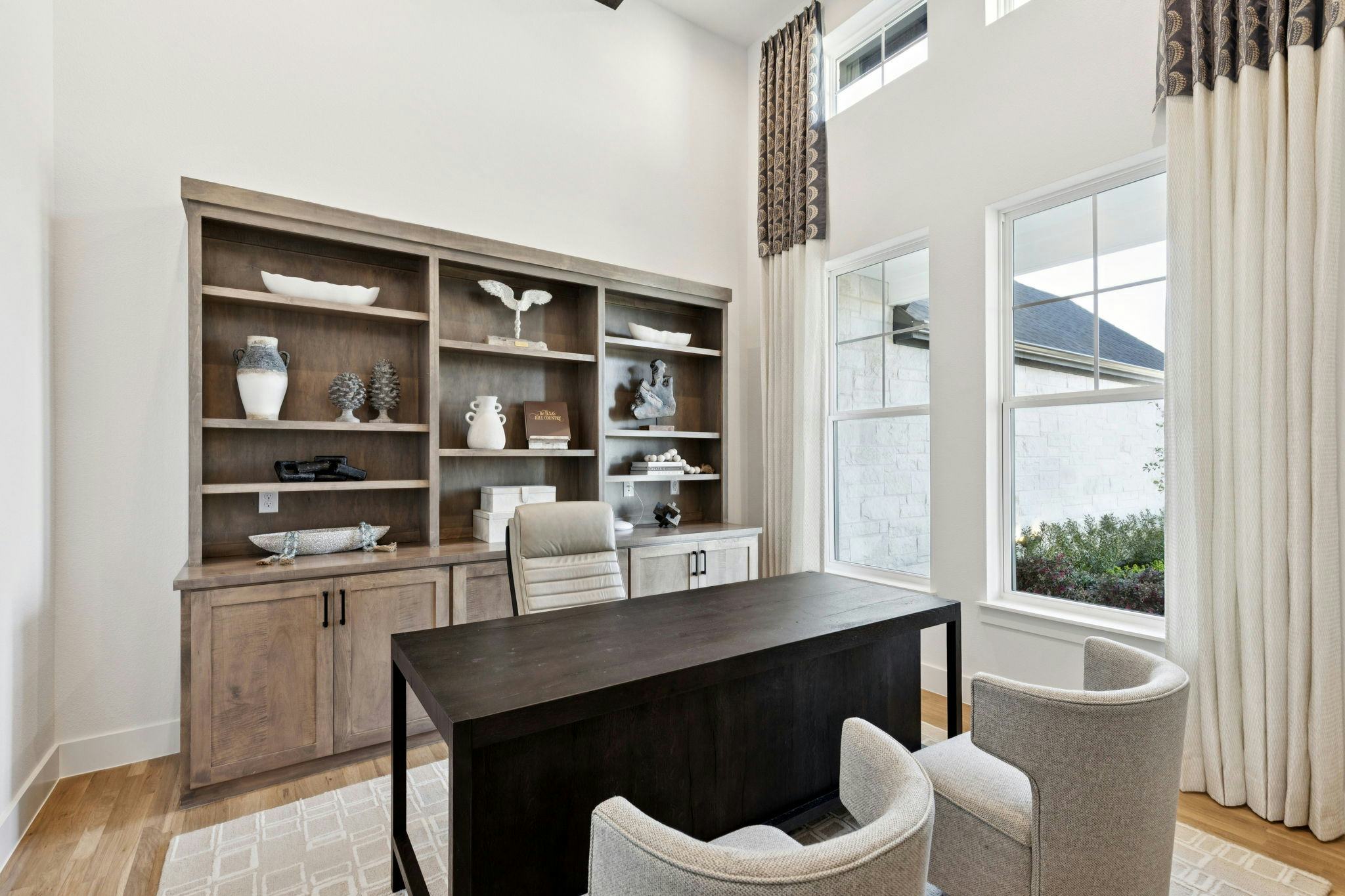 A study with a built-in bookshelf in the custom model home at The Vines by Kindred Homes