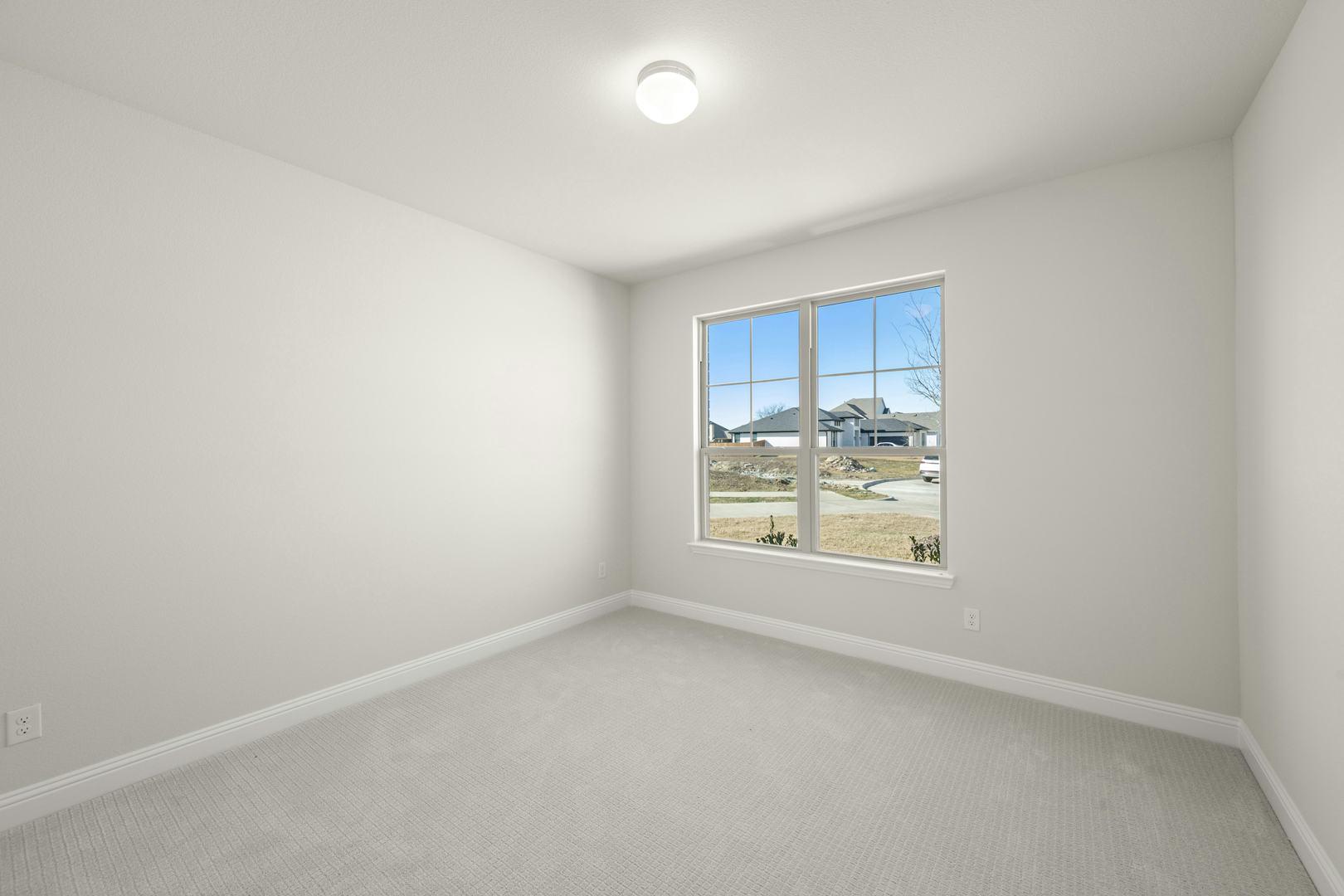 A secondary bedroom in the Willow floor plan by Kindred Homes