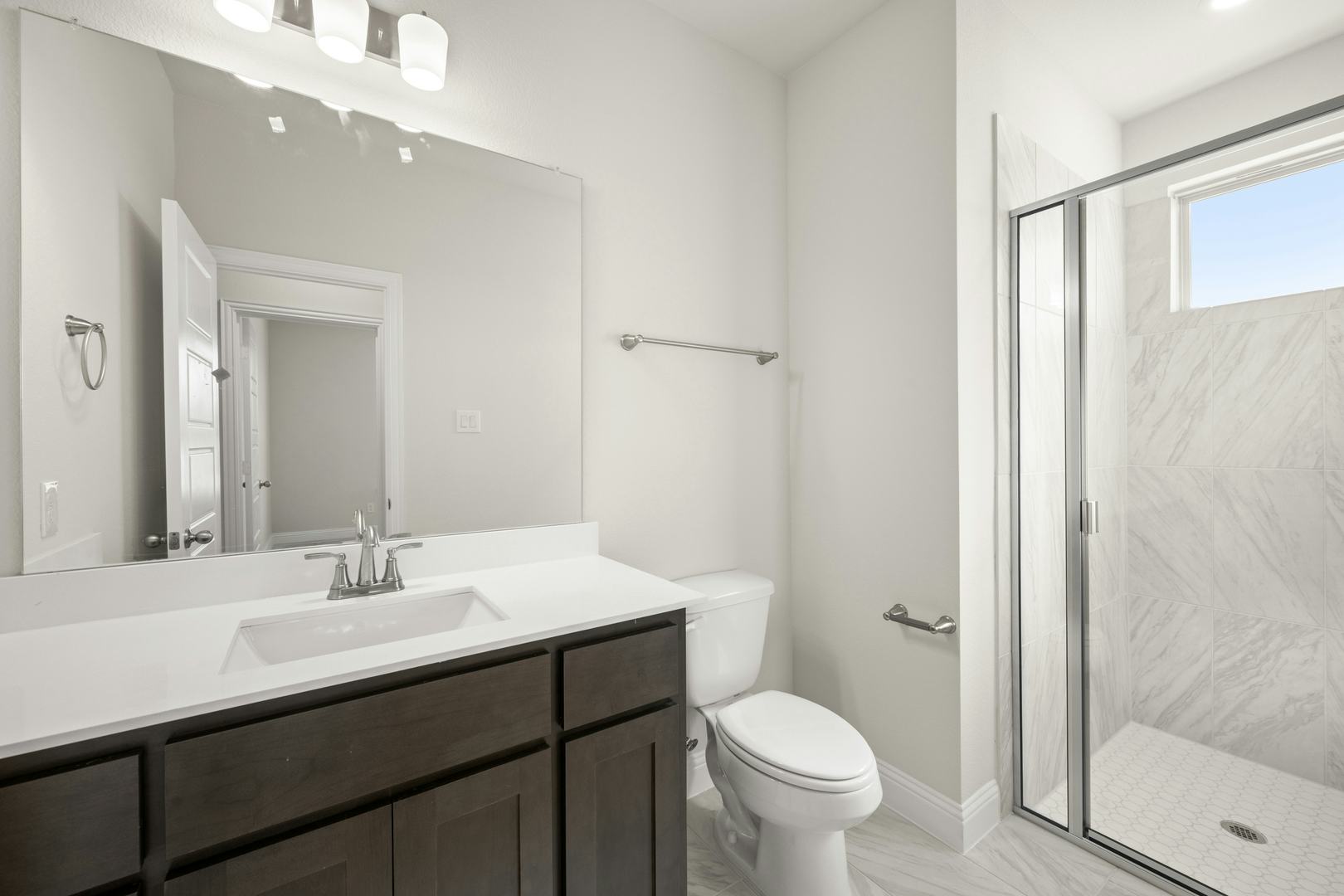 A secondary bathroom in the Willow floor plan by Kindred Homes
