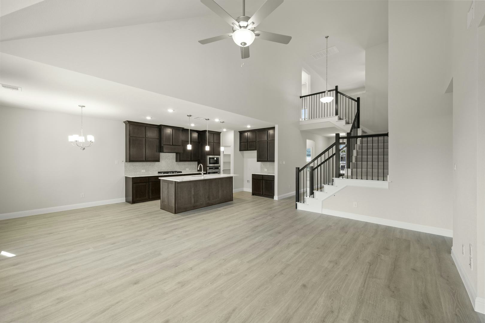 The living room and kitchen in the Willow floor plan by Kindred Homes