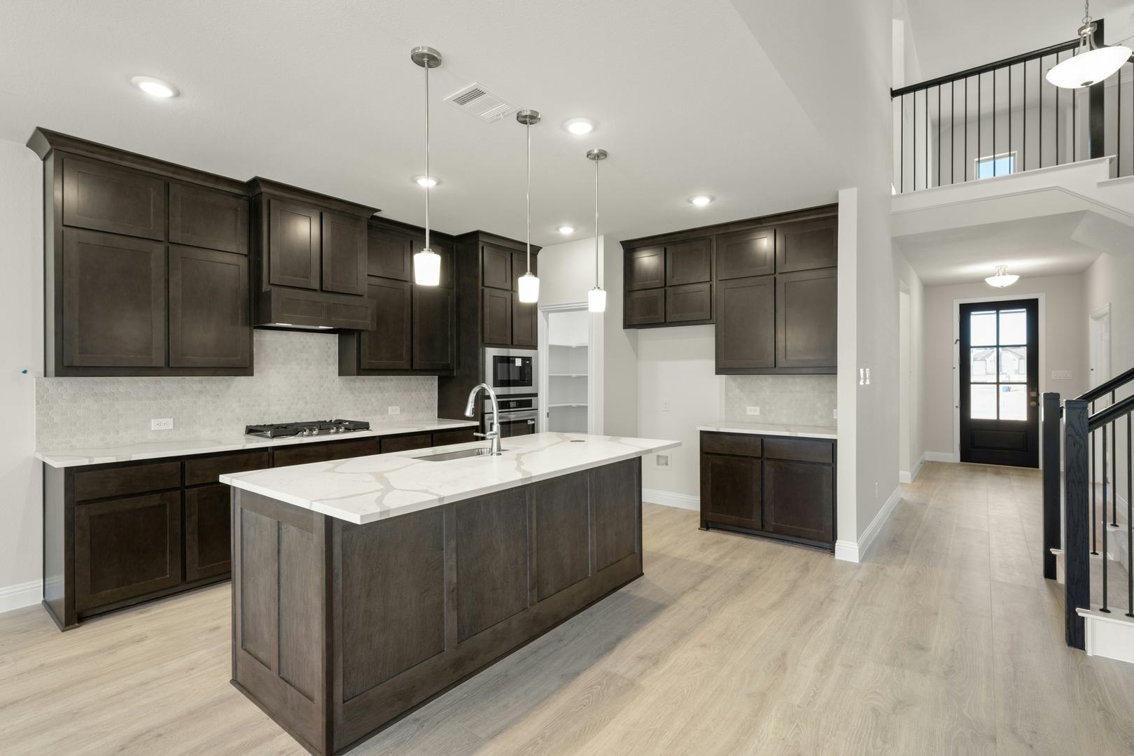 The kitchen in the Willow floor plan by Kindred Homes