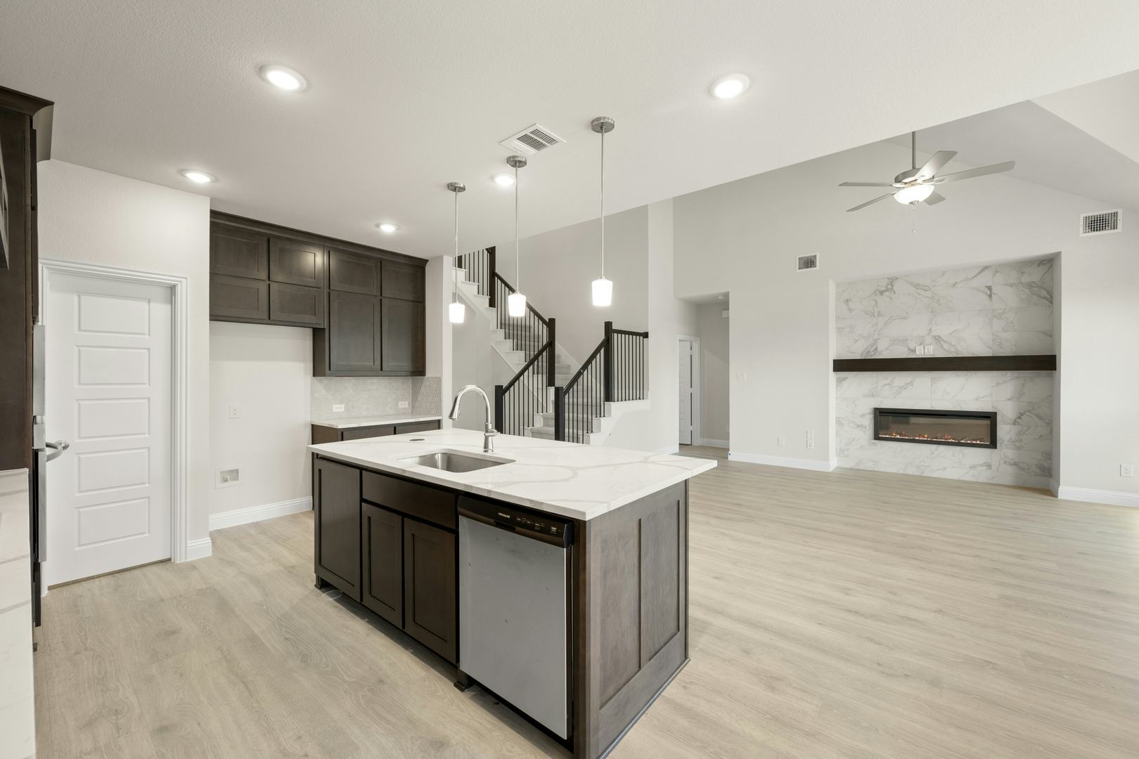 The kitchen and living room in the Willow floor plan by Kindred Homes