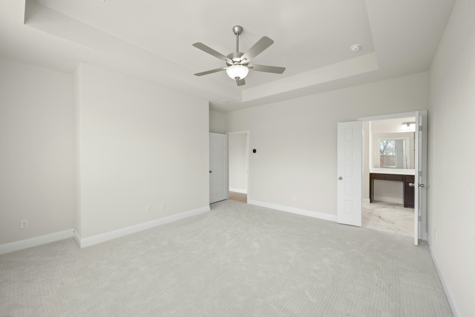 The primary suite bedroom in the Willow floor plan by Kindred Homes