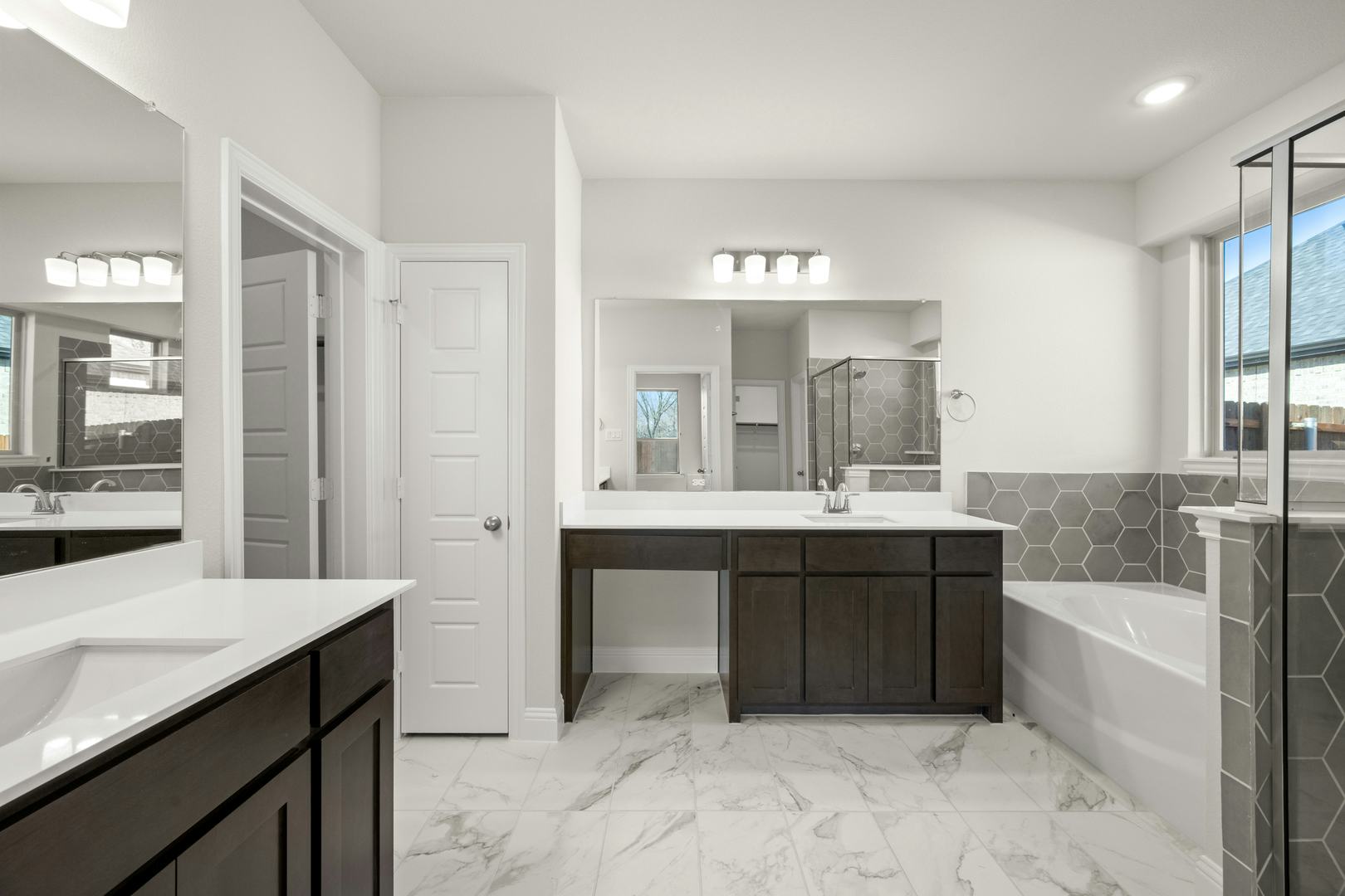 The primary suite bathroom in the Willow floor plan by Kindred Homes
