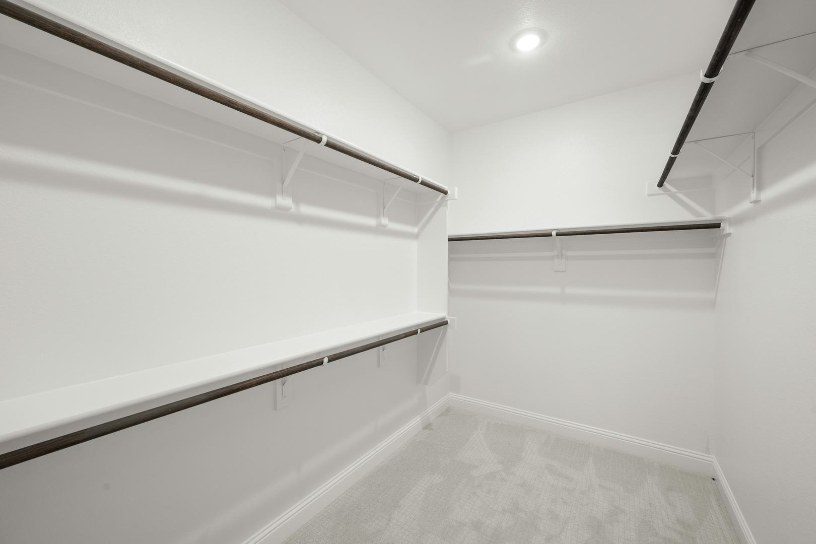 The primary suite closet in the Willow floor plan by Kindred Homes