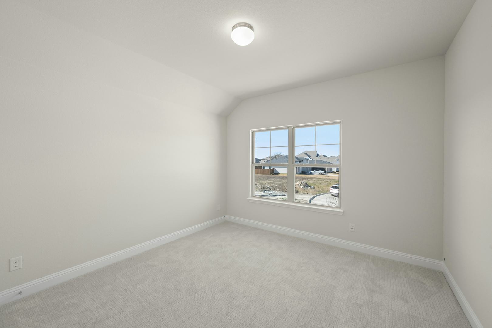 A secondary bedroom in the Willow floor plan by Kindred Homes