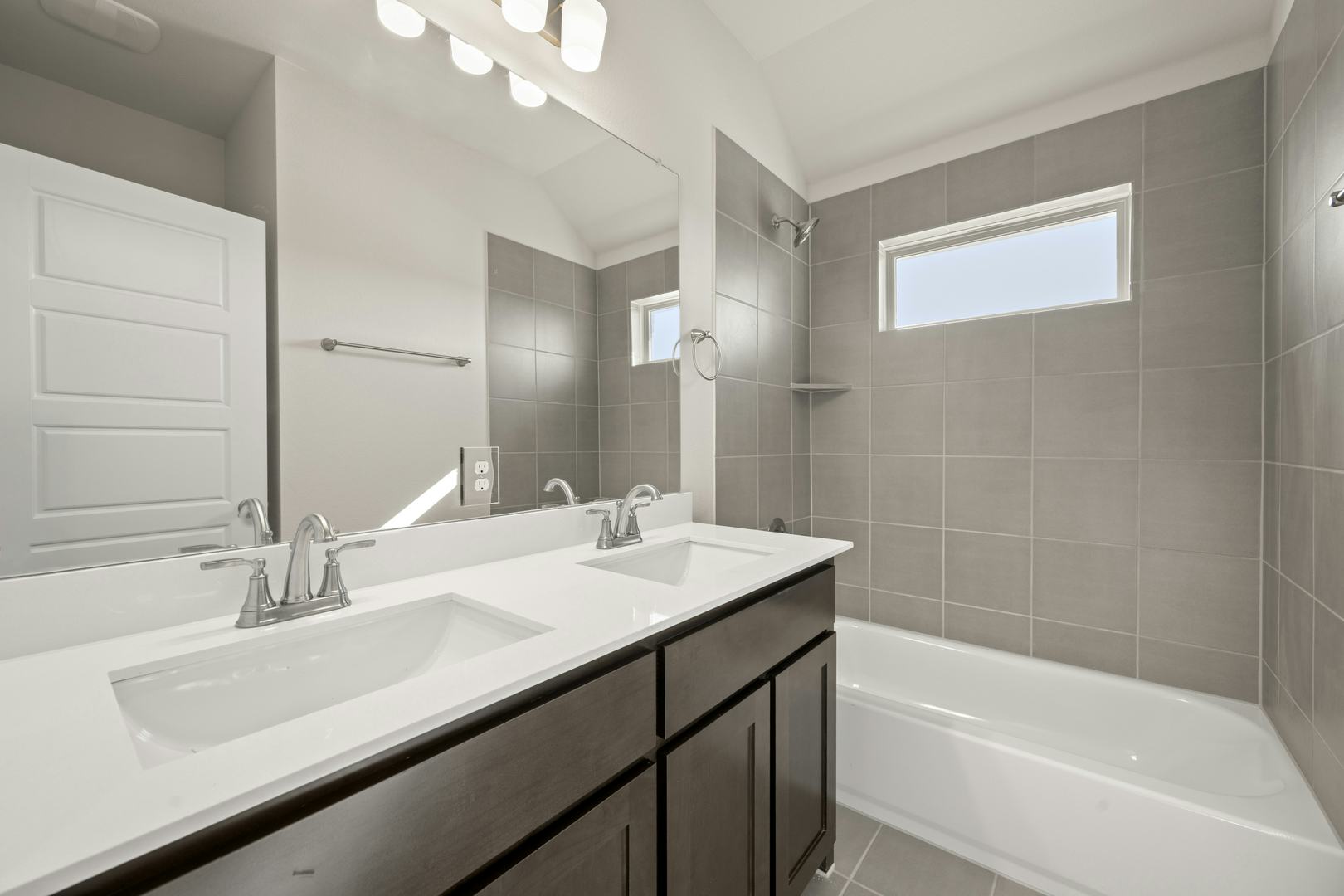 A secondary bathroom in the Willow floor plan by Kindred Homes