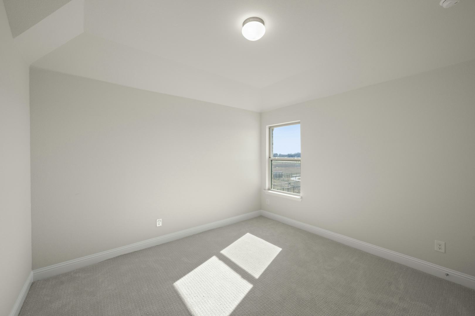 A secondary bedroom in the Willow floor plan by Kindred Homes