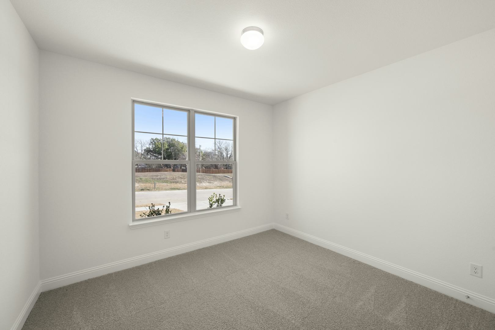 A secondary bedroom in the Cherry floor plan by Kindred Homes