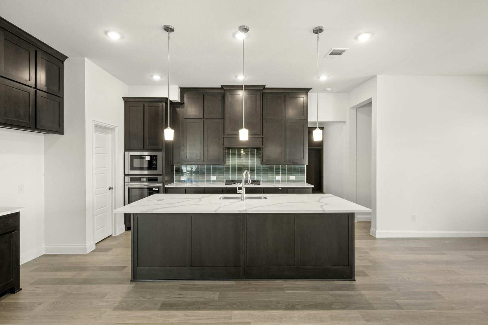 The kitchen in the Cherry floor plan by Kindred Homes
