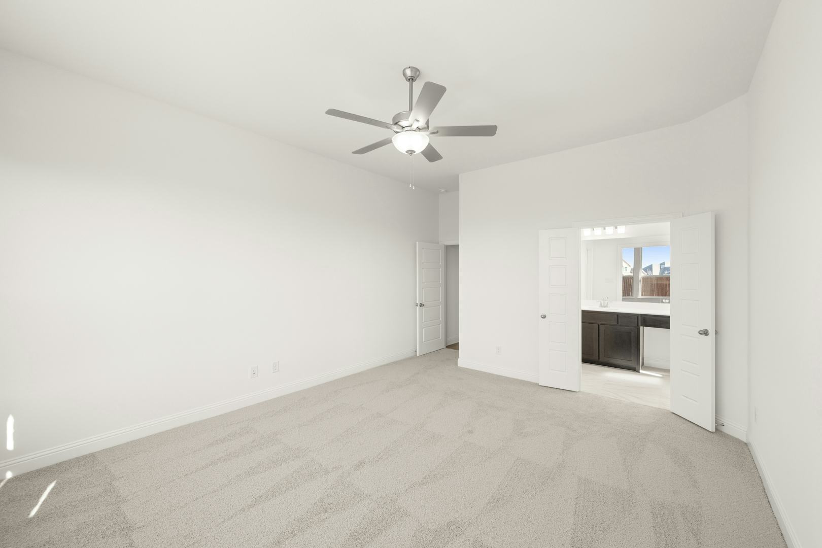 The primary bedroom in the Cherry floor plan by Kindred Homes