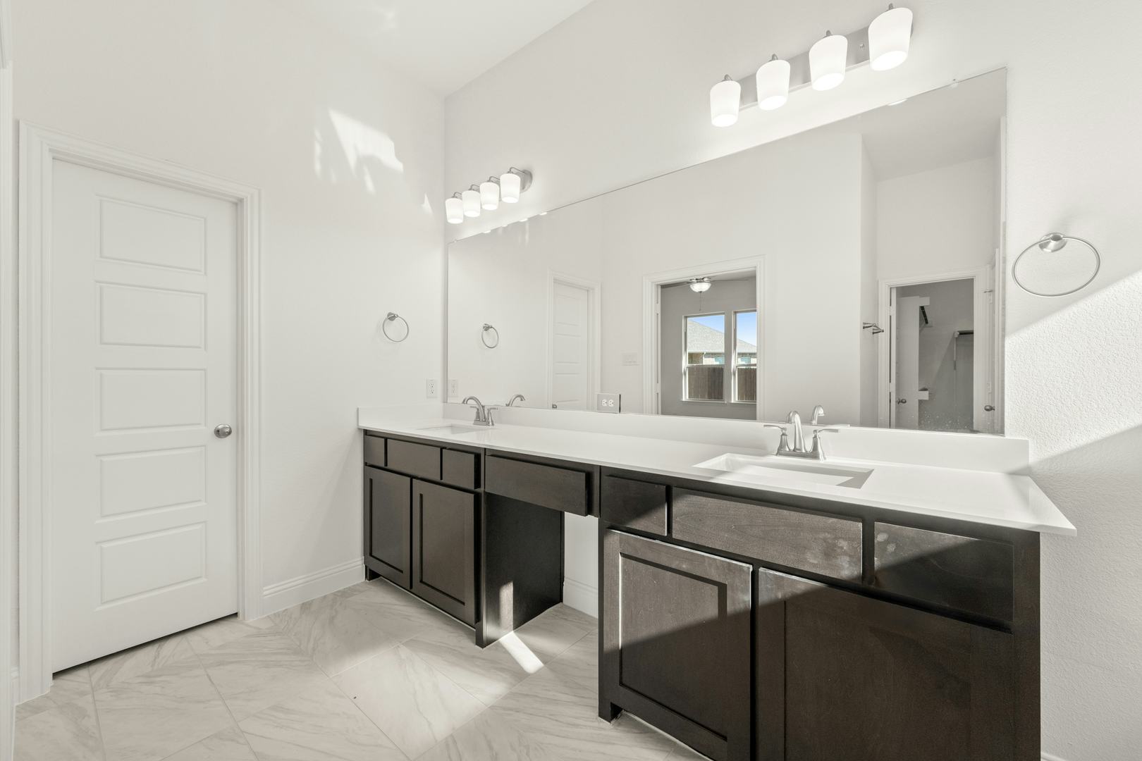 The primary bathroom with a dual vanity in the Cherry floor plan by Kindred Homes