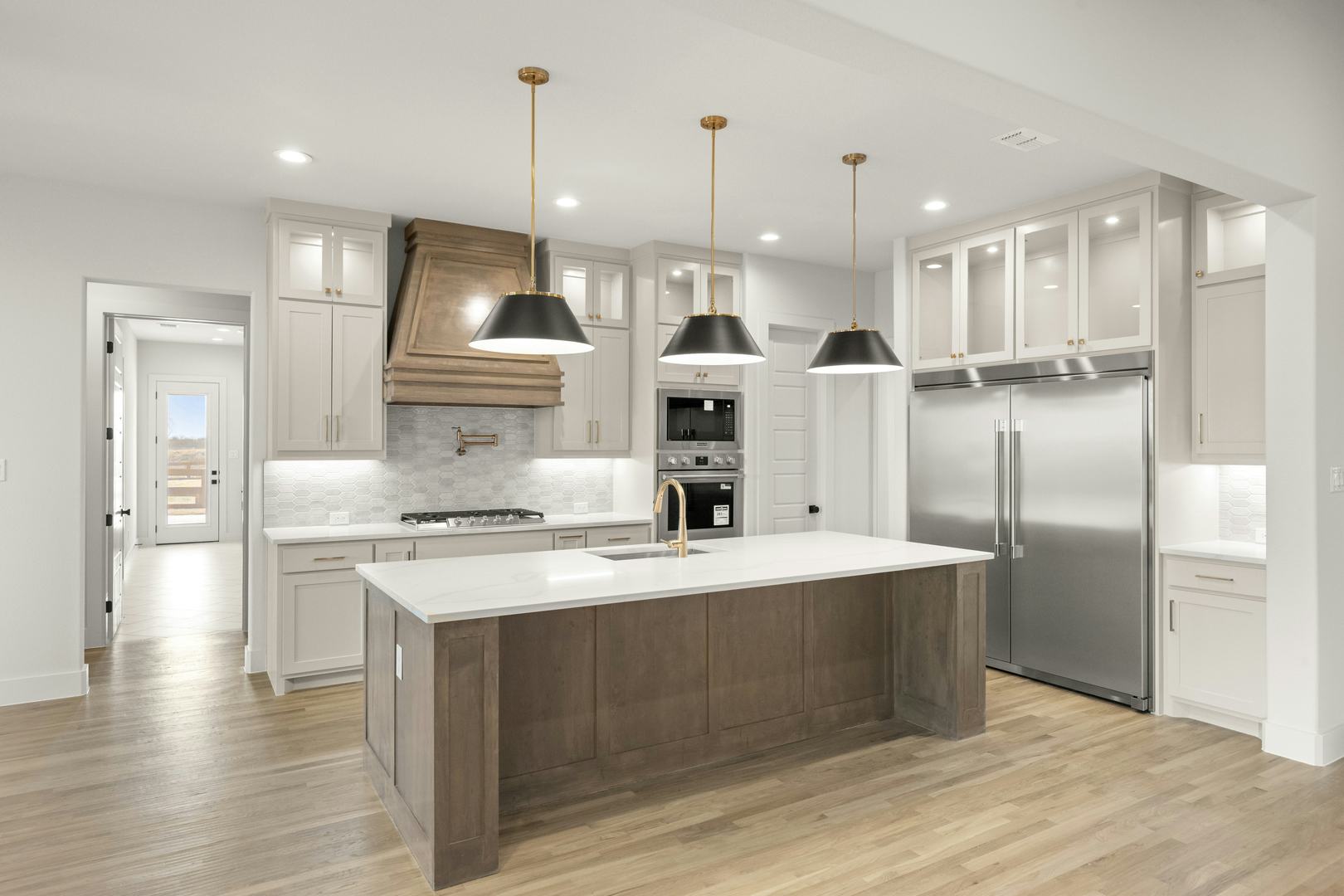 Kitchen in a custom home at Highlands of Northlake by Kindred Homes