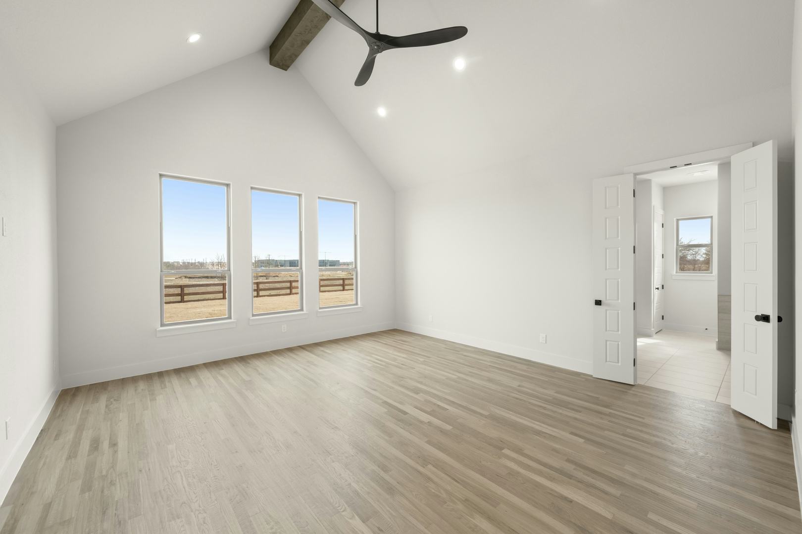 Primary bedroom in a custom home at Highlands of Northlake by Kindred Homes