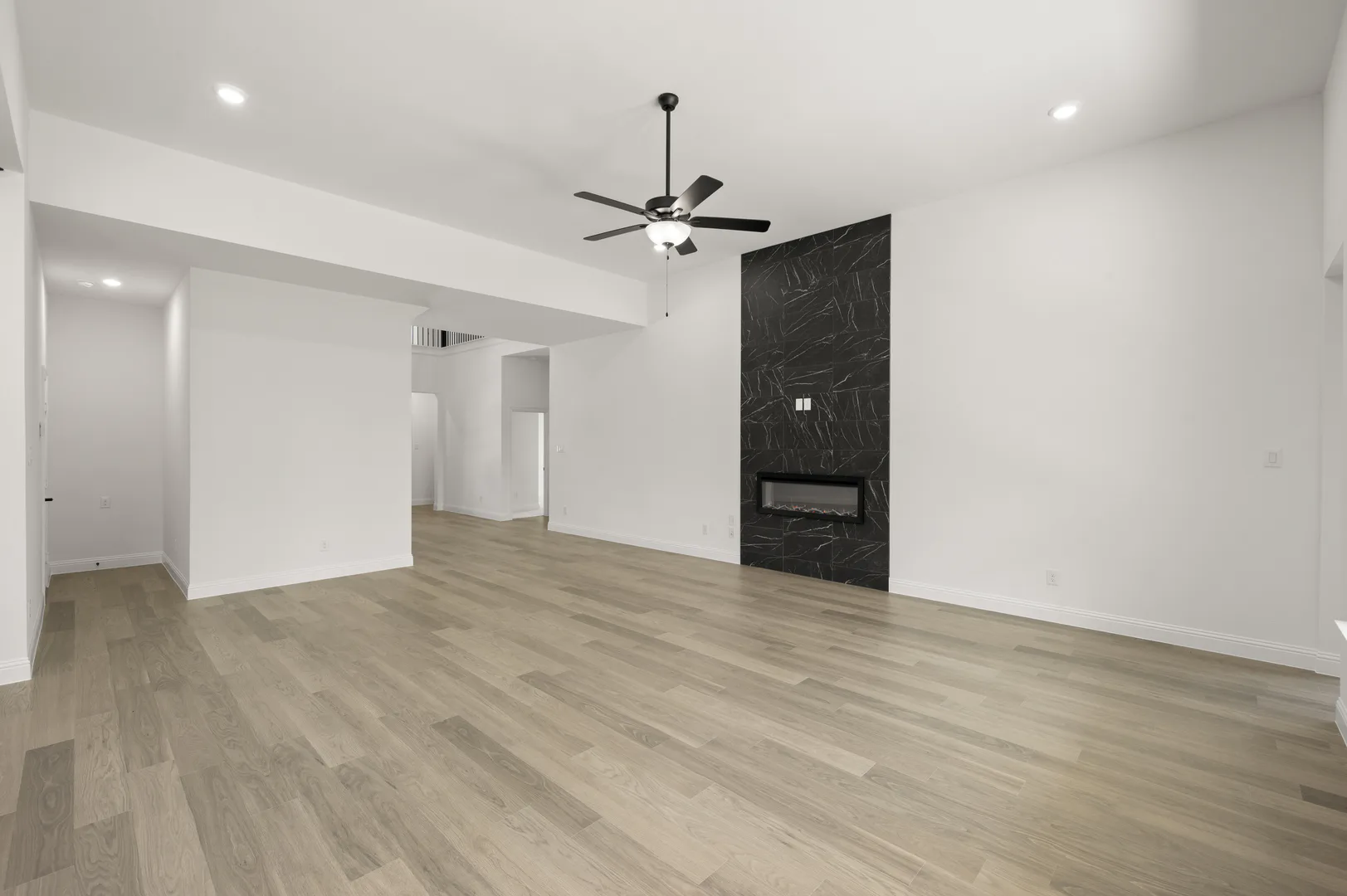 Open concept living room with fireplace in available home at Westside Preserve by Kindred Homes in Midlothian