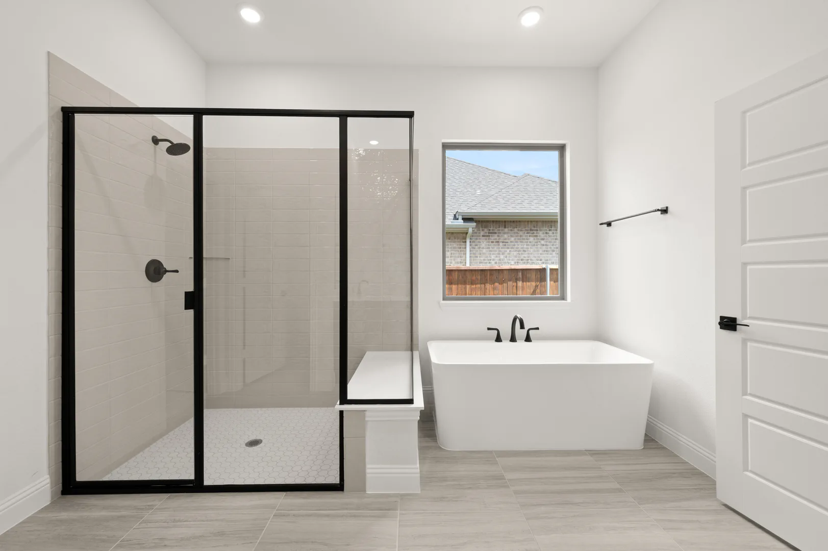 Primary bathroom with walk-in shower and free-standing tub in available home at Westside Preserve by Kindred Homes in Midlothian