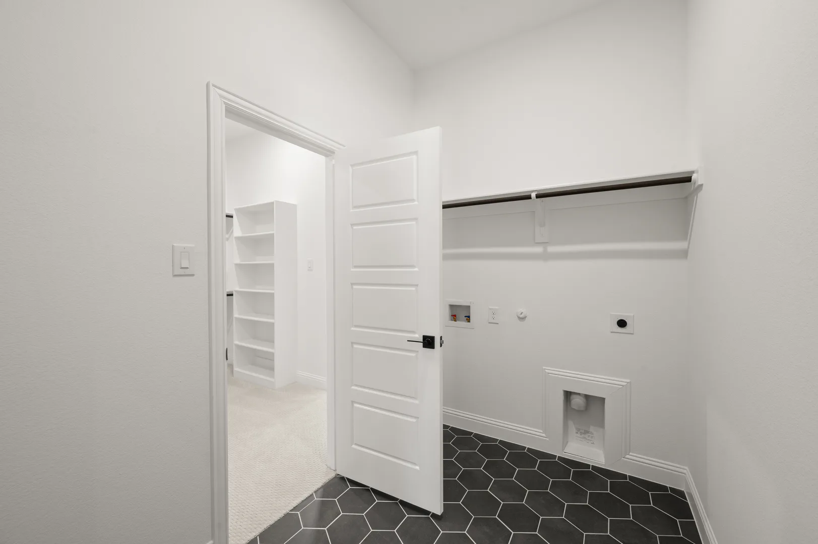 Utility room with hexagon tiles in available home at Westside Preserve by Kindred Homes in Midlothian