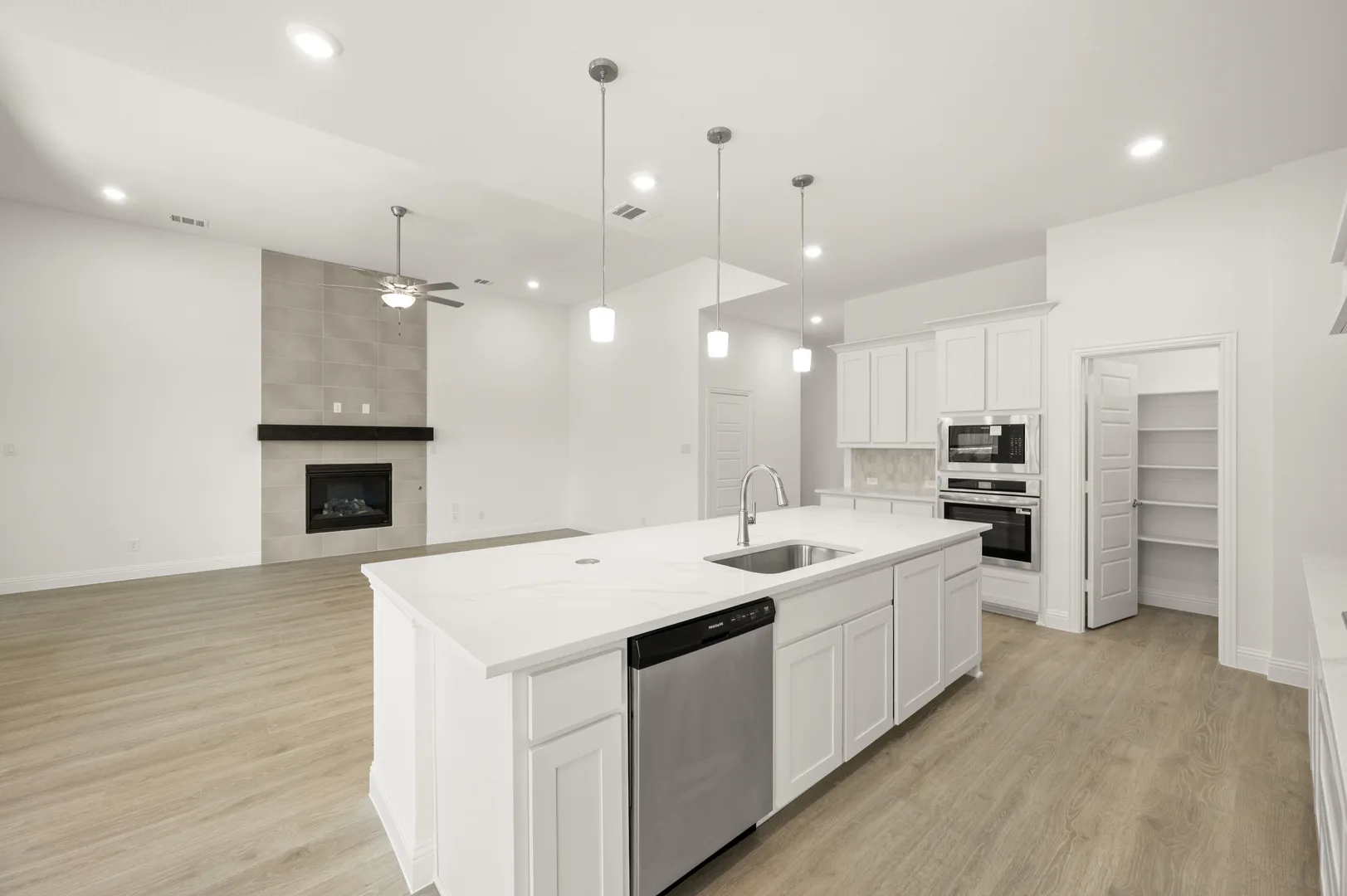 Kitchen and living room in available home at Westside Preserve by Kindred Homes in Midlothian