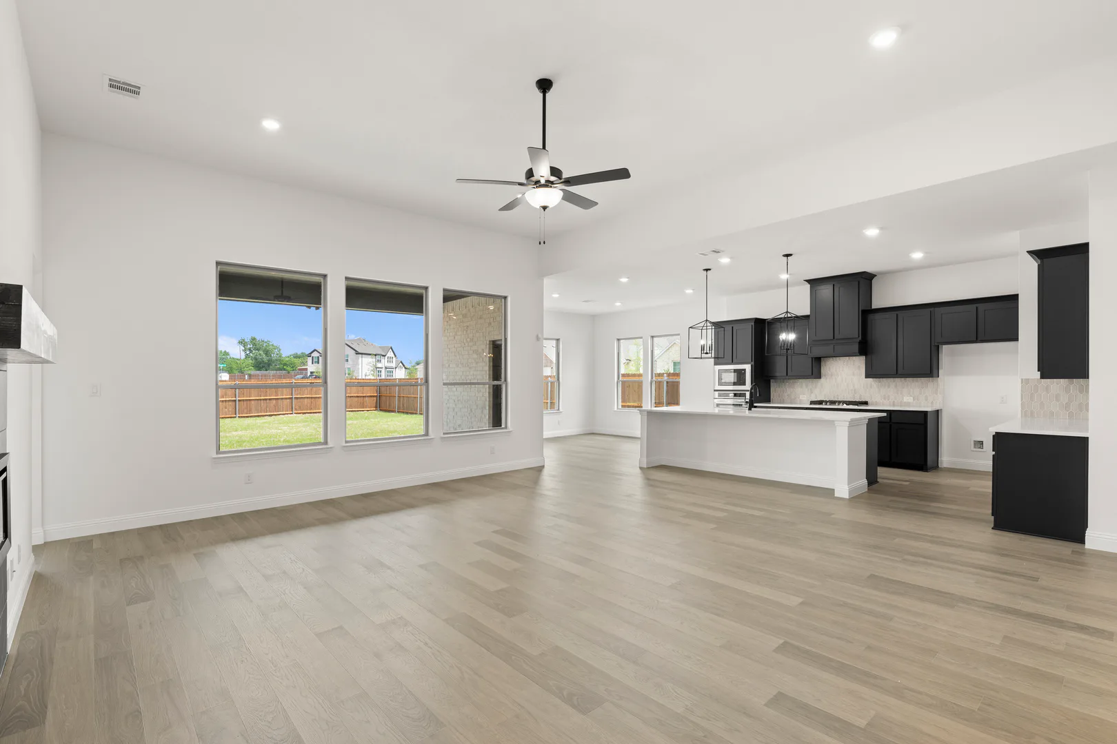 Living room and kitchen area in available home at Park Trails by Kindred Homes in Forney