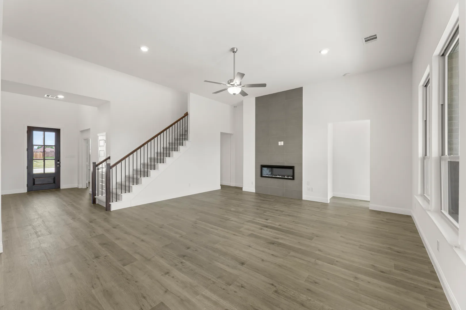 Living room and linear fireplace in a new home available at Park Trails by Kindred Homes in Forney
