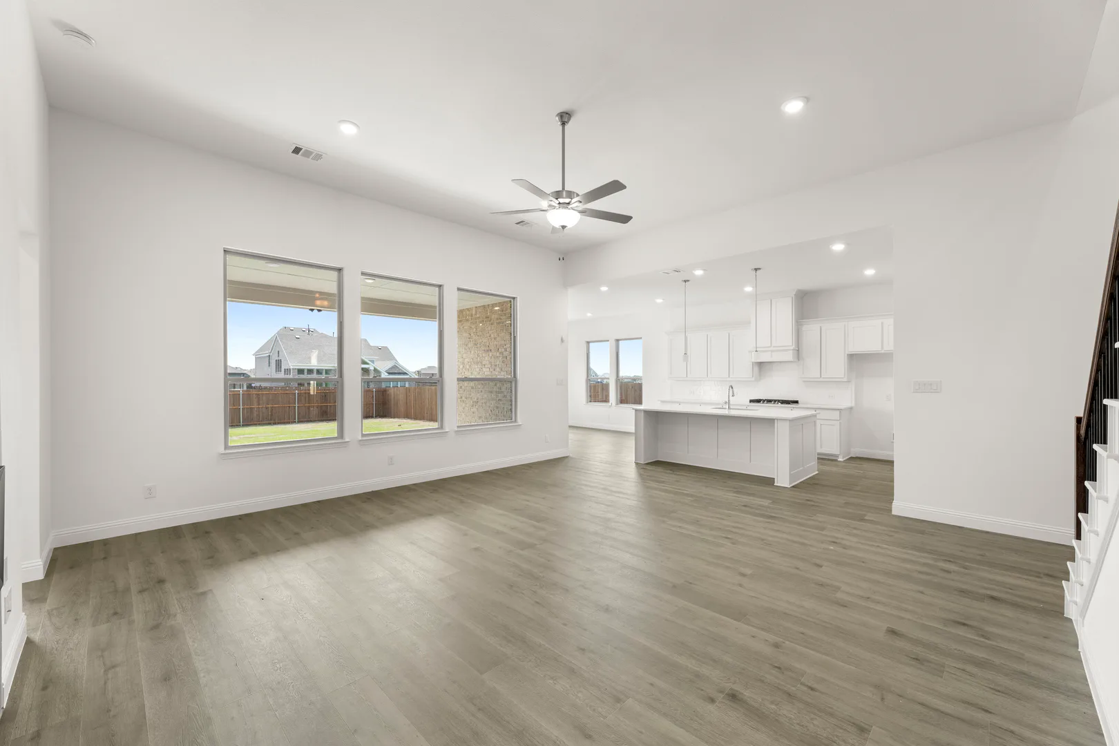 Open concept living room and kitchen area in a new home available at Park Trails by Kindred Homes in Forney