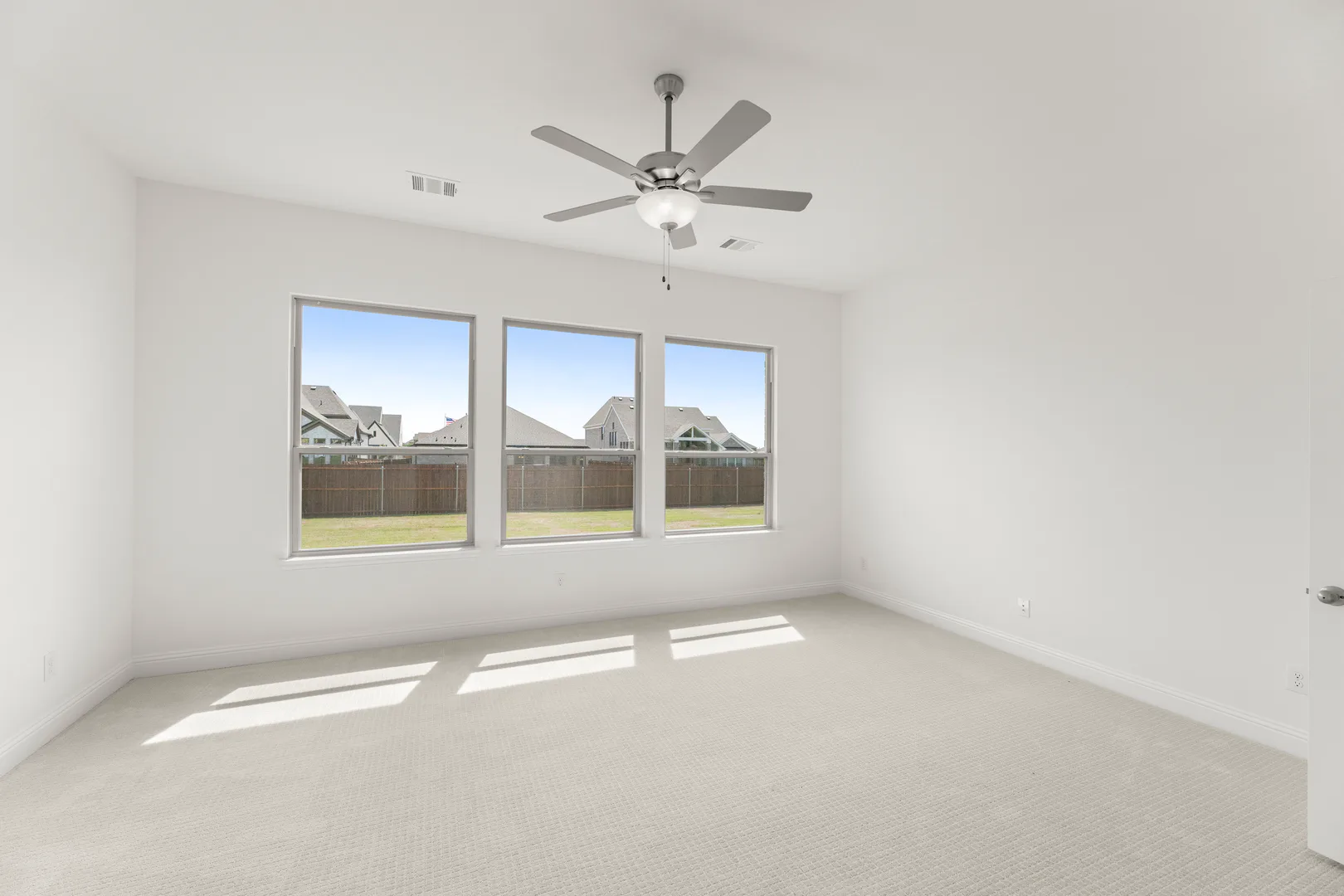 Primary bedroom with natural light in a new home available at Park Trails by Kindred Homes in Forney