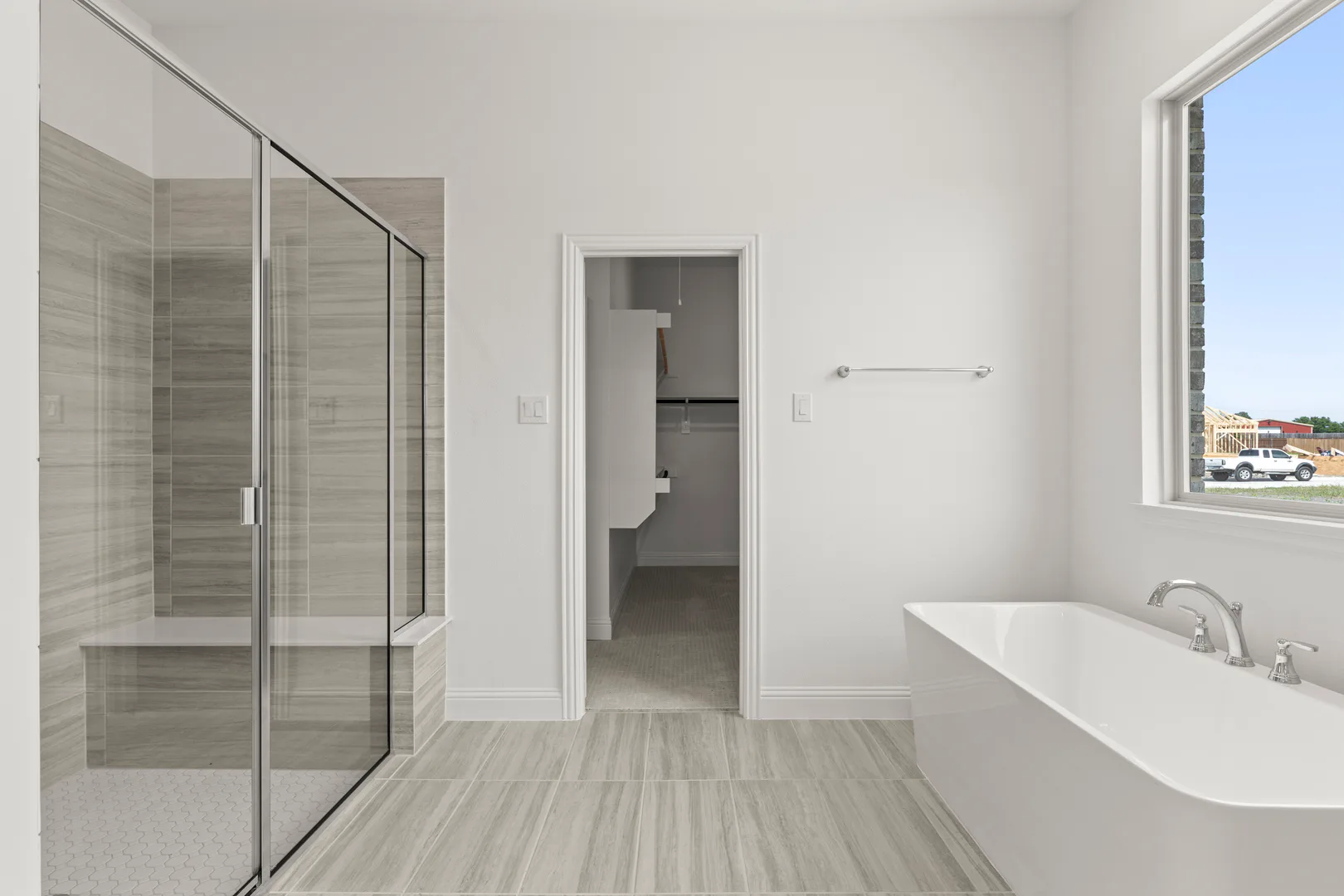 Free standing tub in the primary bathroom in a new home available at Park Trails by Kindred Homes in Forney