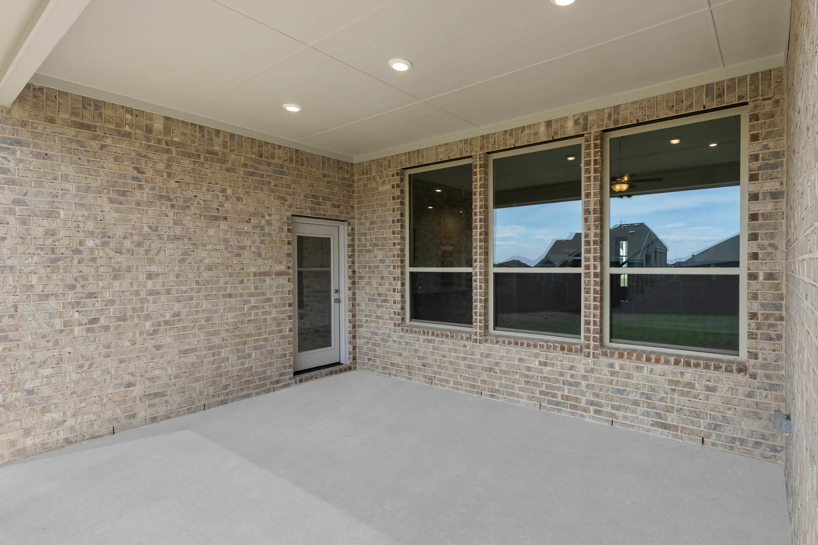 Covered outdoor living in a new home available at Park Trails by Kindred Homes in Forney