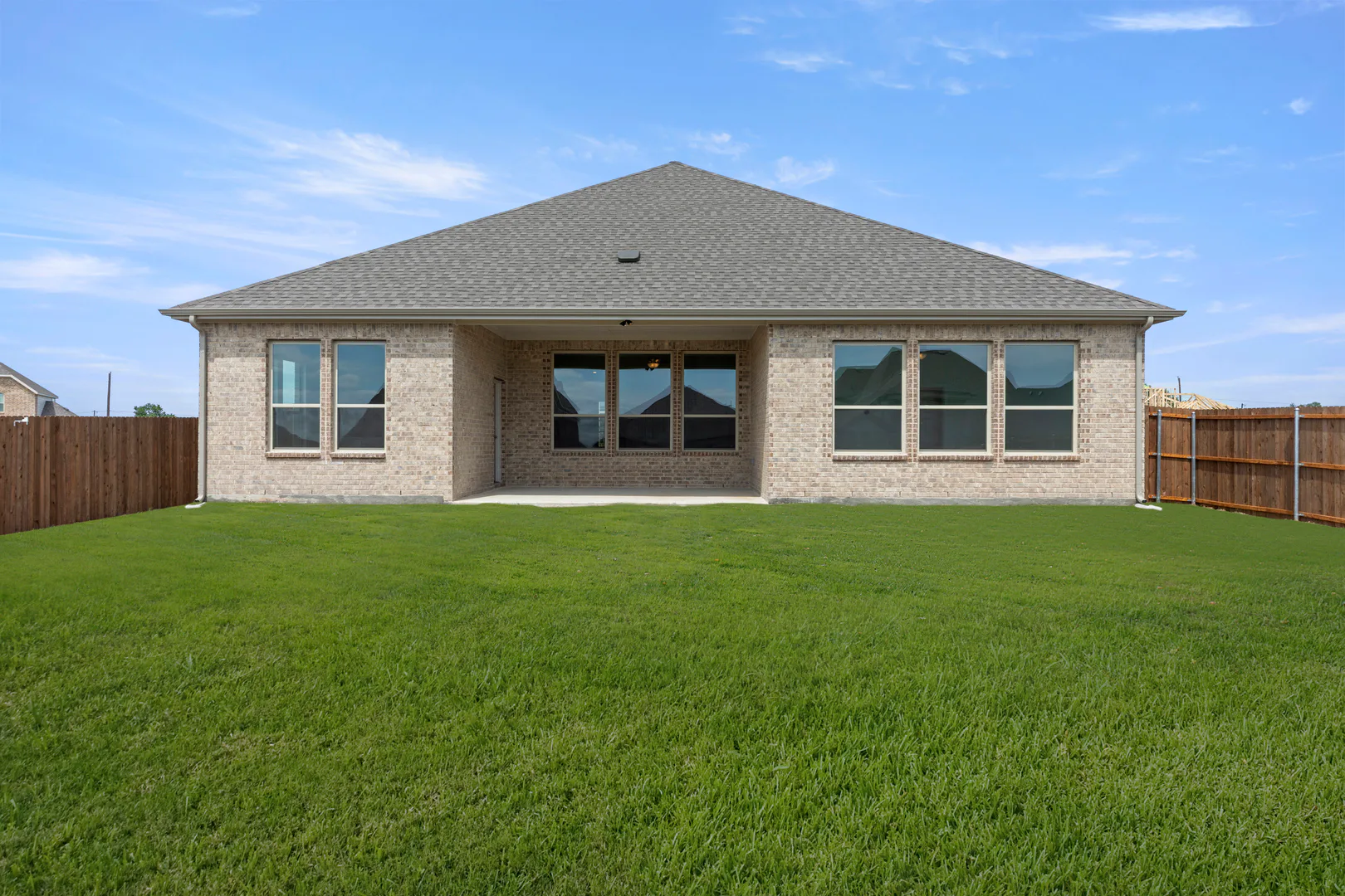 Back exterior in a new home available at Park Trails by Kindred Homes in Forney