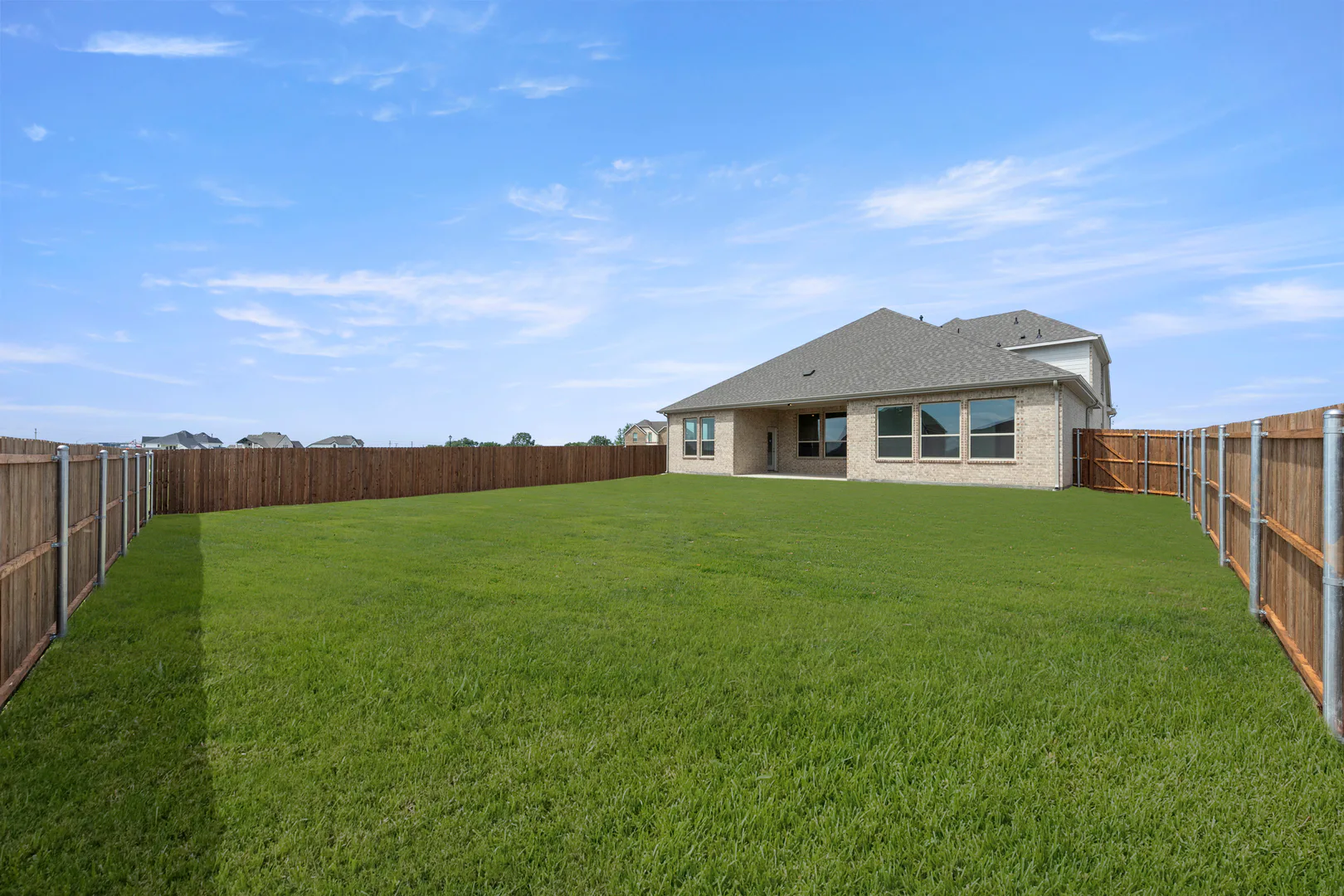 Spacious backyard in a new home available at Park Trails by Kindred Homes in Forney