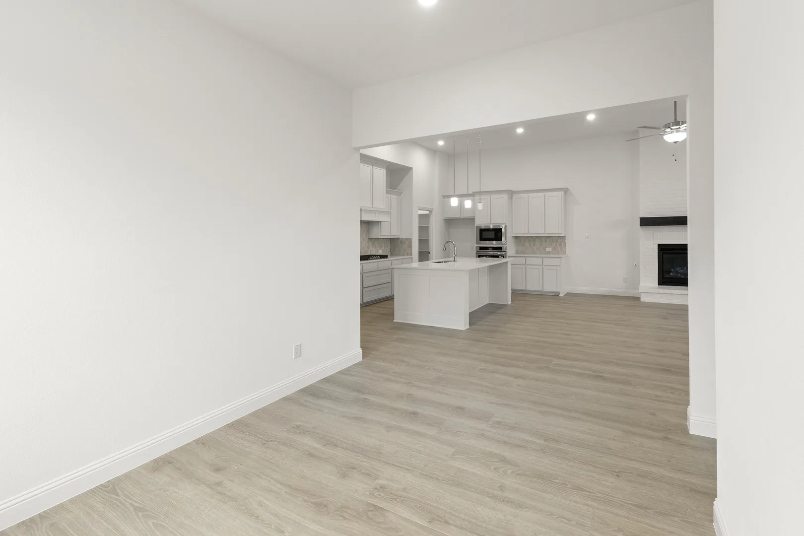 Open concept dining room and kitchen in a modern tudor style home by Kindred Homes