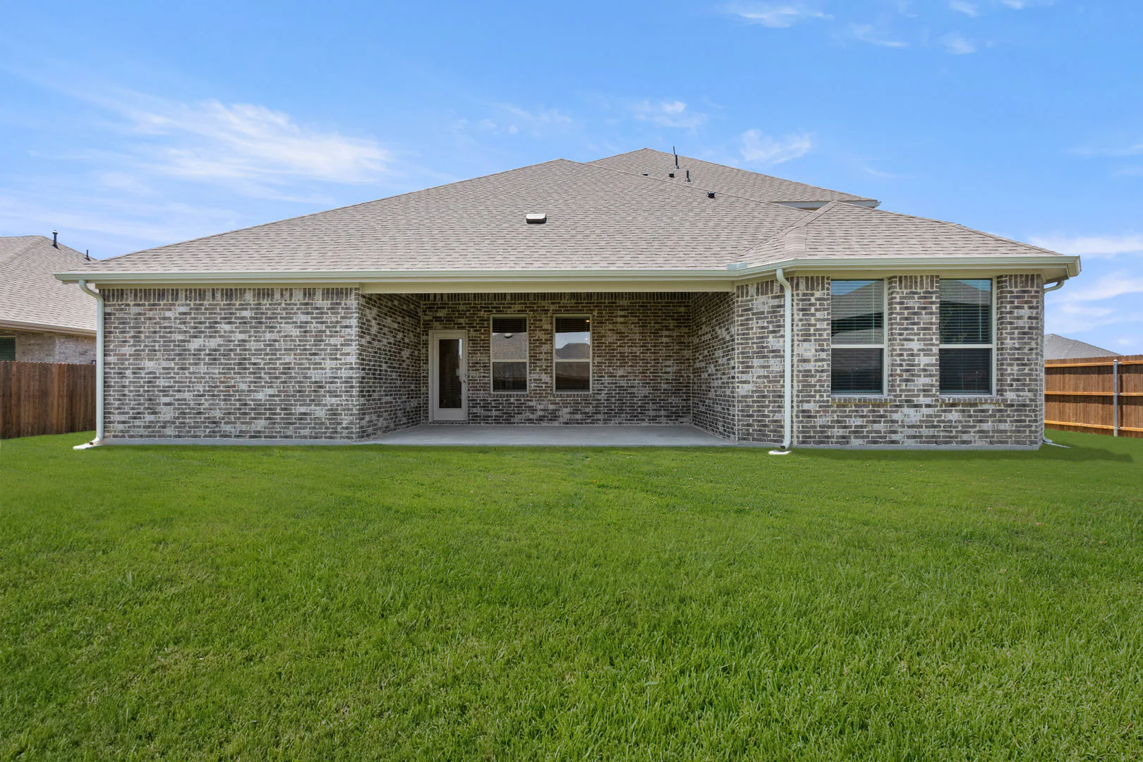 Back exterior of a new traditional style home by Kindred Homes