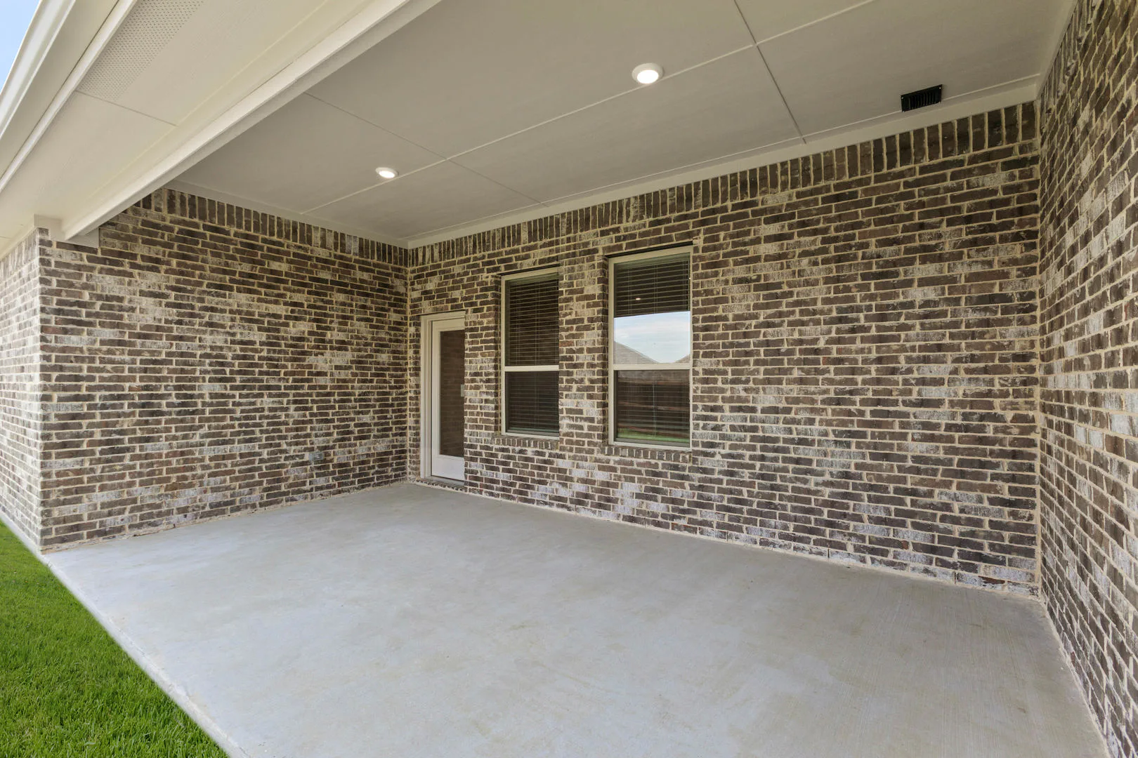 Covered patio of a new traditional style home by Kindred Homes
