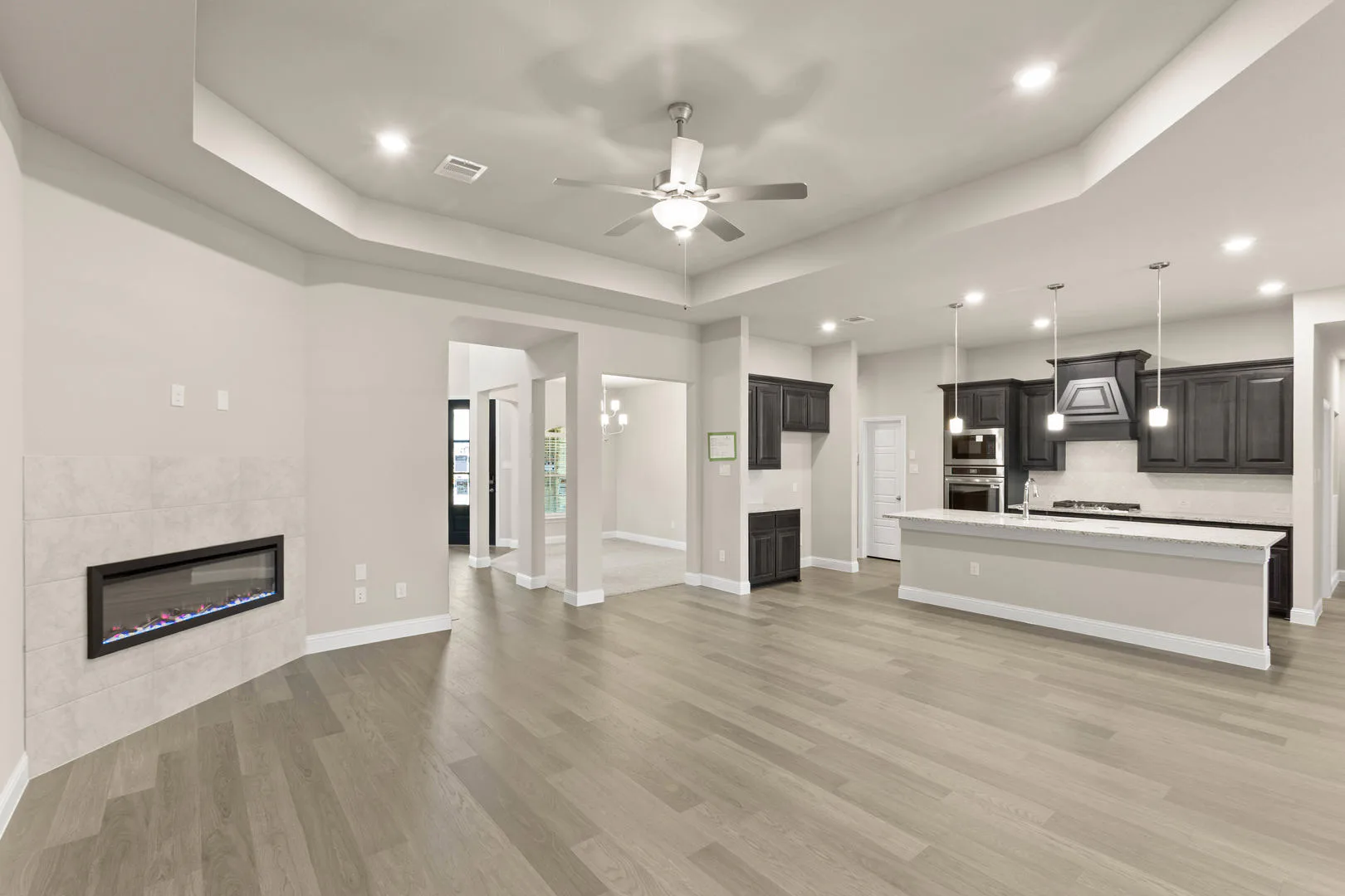 Living room and kitchen in a new traditional style home by Kindred Homes
