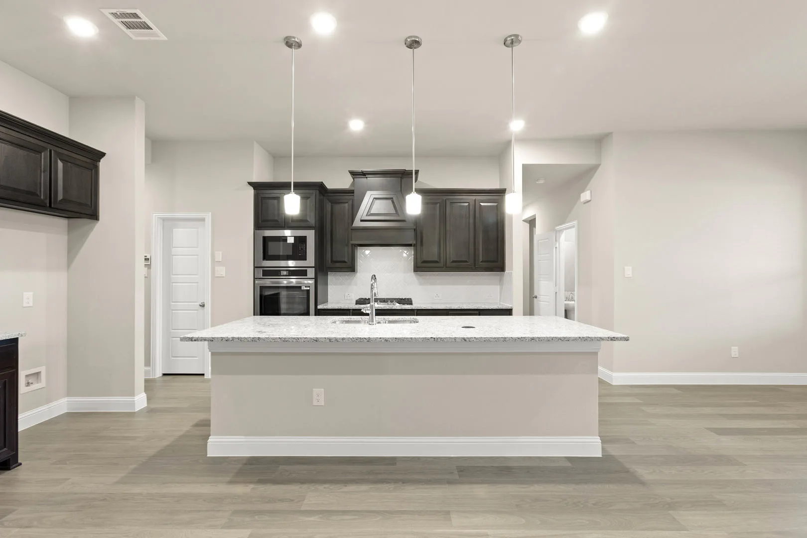 Kitchen in a new traditional style home by Kindred Homes