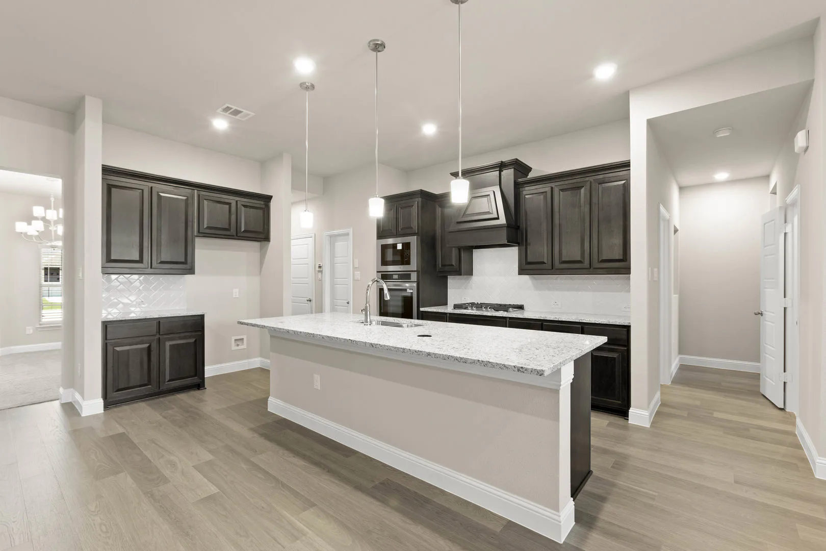 Kitchen in a new traditional style home by Kindred Homes
